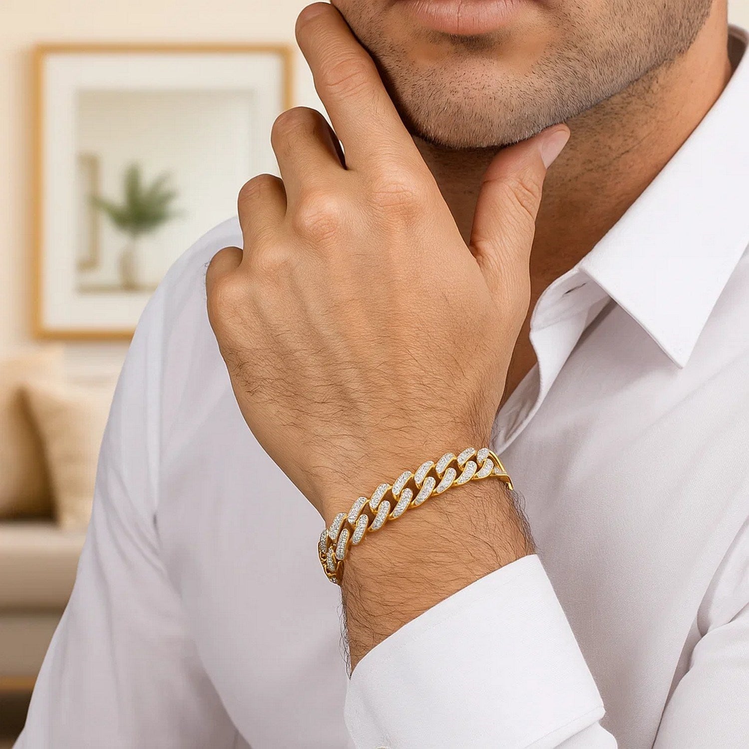 A man wears a two-tone gold curb chain bracelet with diamond pave links.