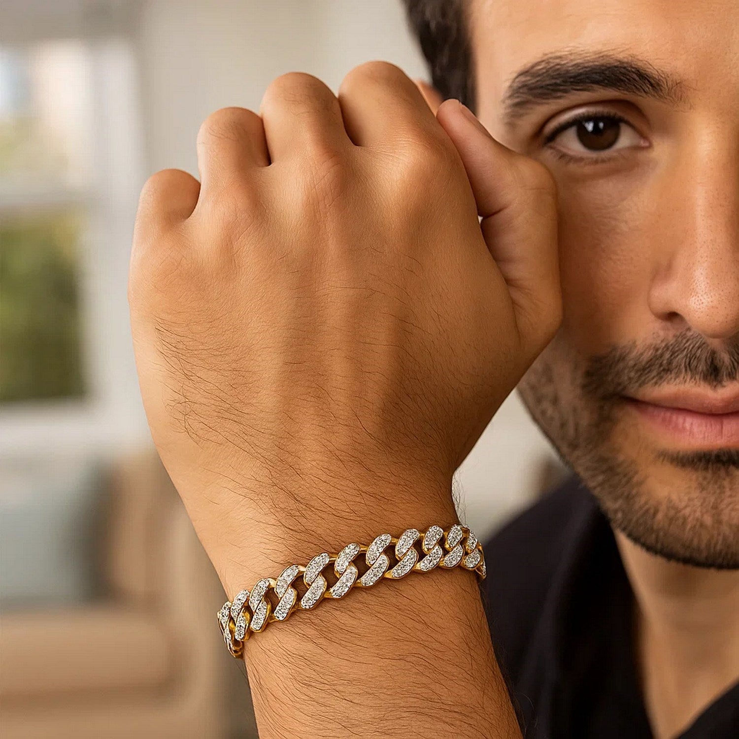 A man wears a 14k two-tone gold curb chain bracelet with diamond pave links.