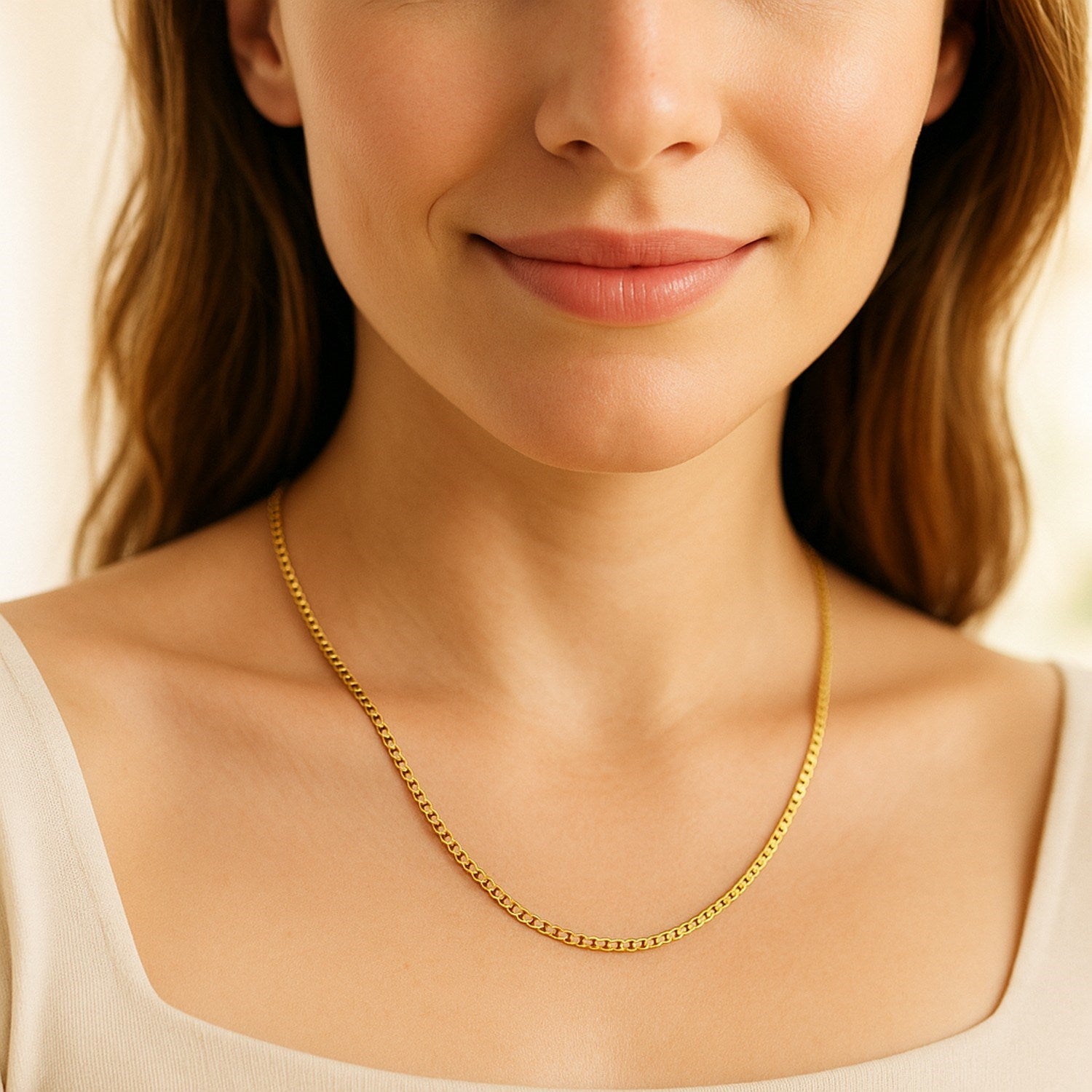 A woman wears a 14K yellow gold classic box chain.