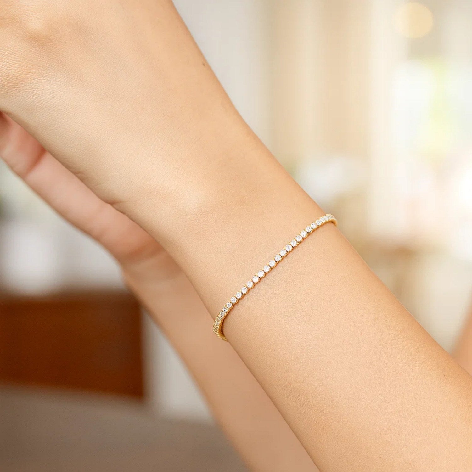 A 14K two-tone gold Diamon Oro tennis bracelet with a single row of diamonds.