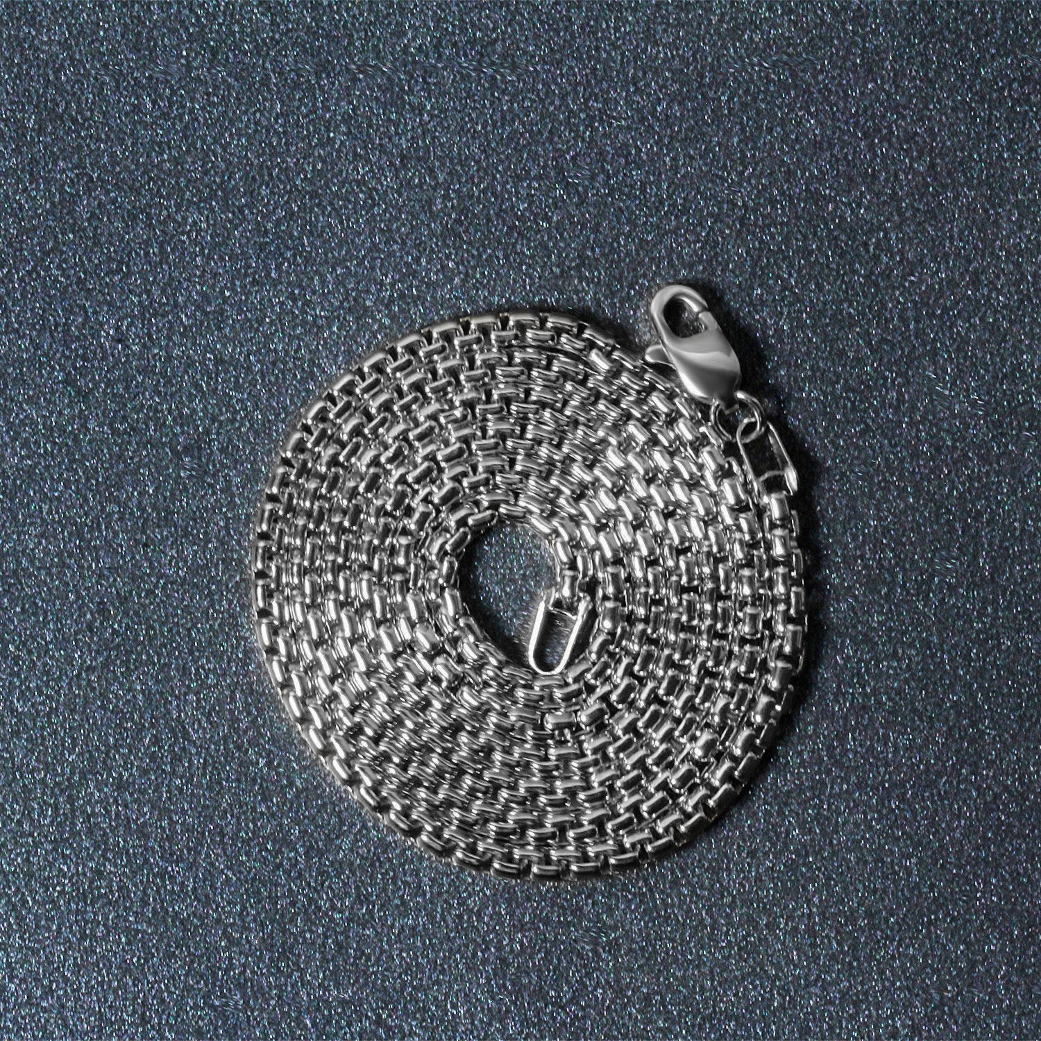 A coiled 14k white gold solid round box chain with a lobster clasp.