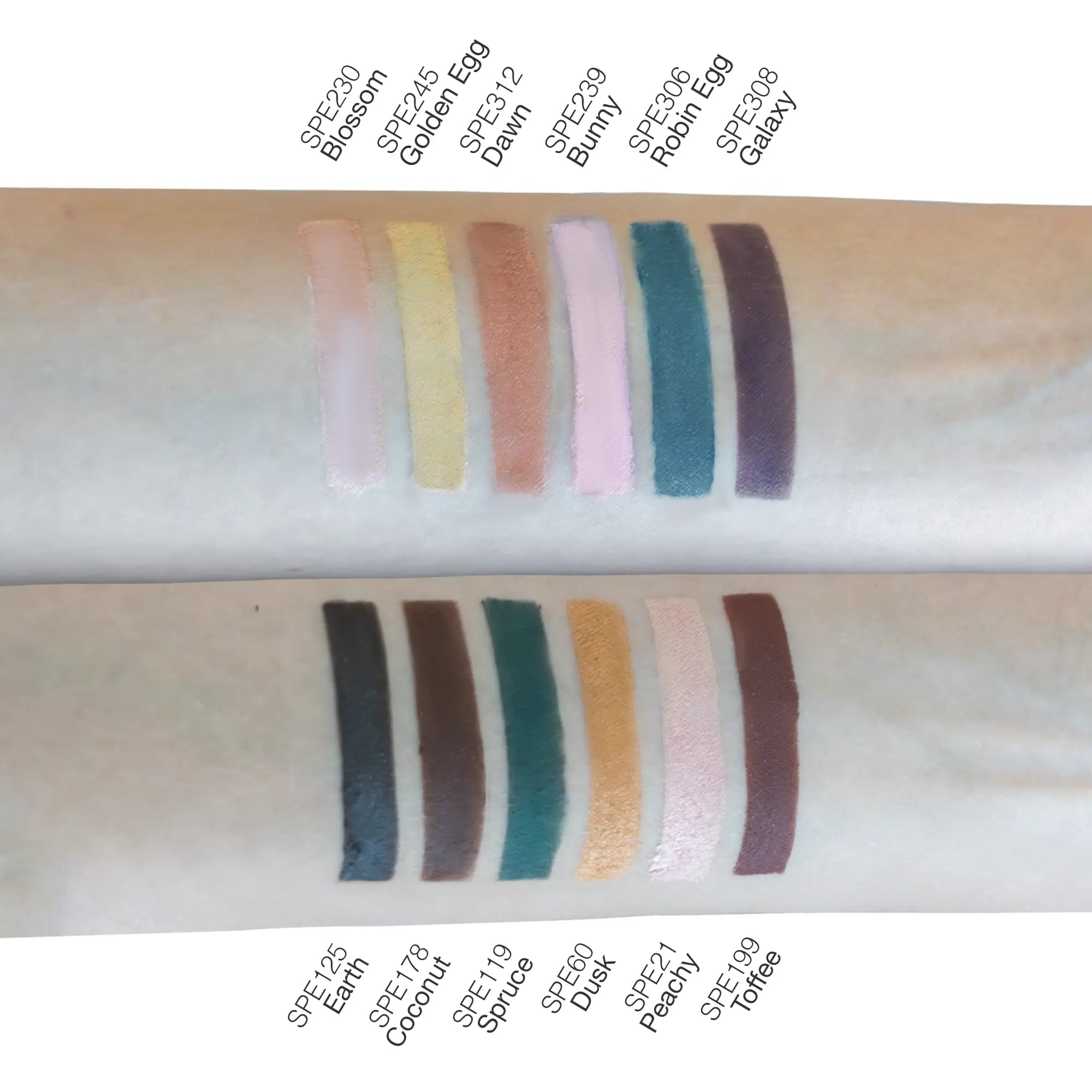 Two rows of eyeshadow swatches on skin, with color names labeled above and below.
