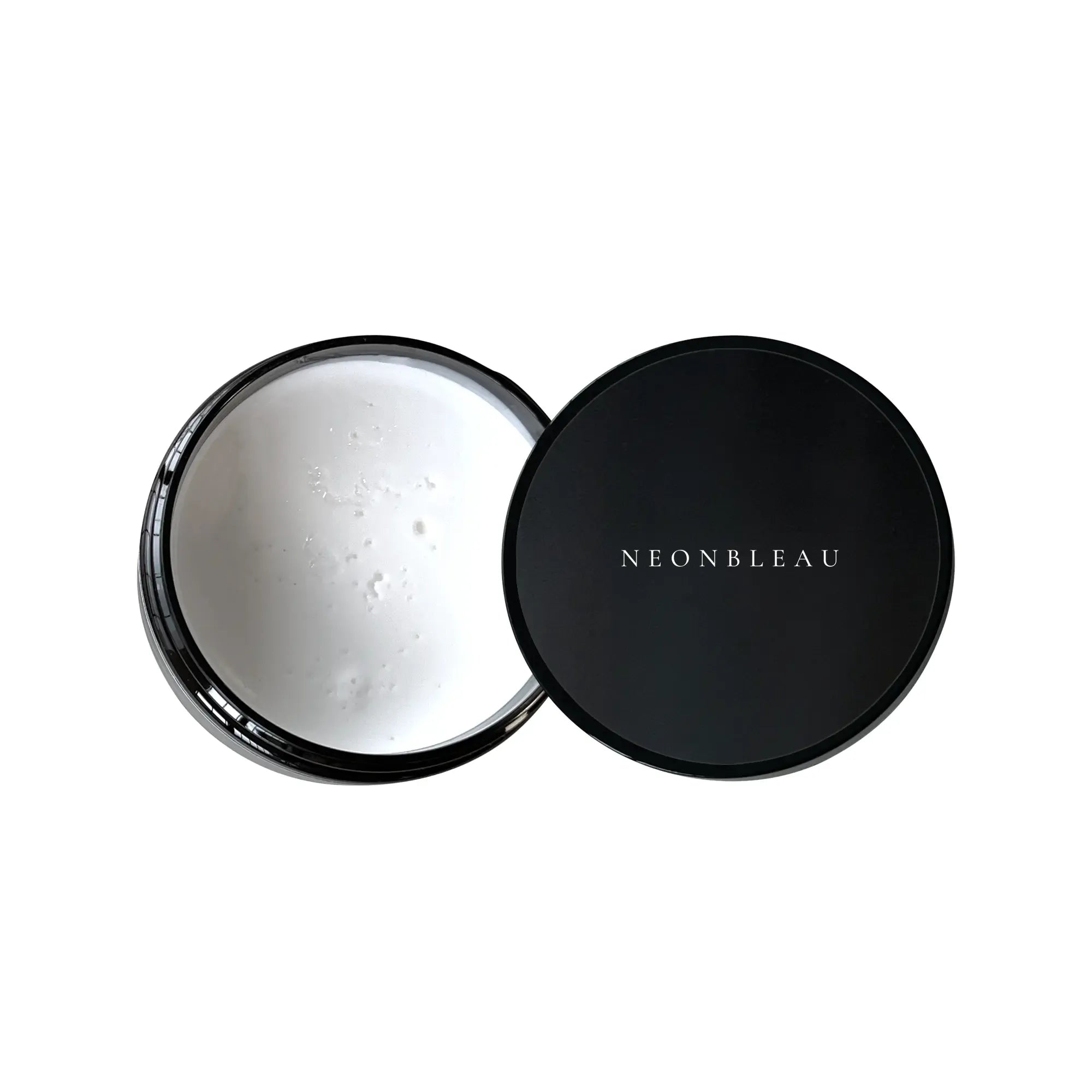 An open black jar of white hair clay sits next to its black lid with "NEONBLEAU" written on it.