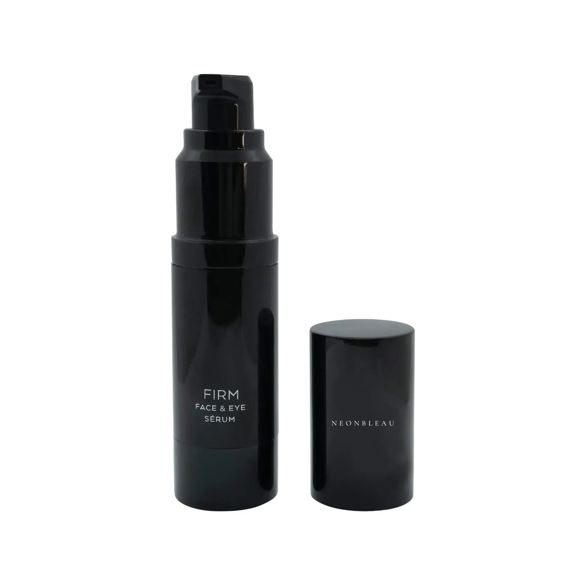 Black pump bottle of Firm Face & Eye Sérum with its cap beside it.