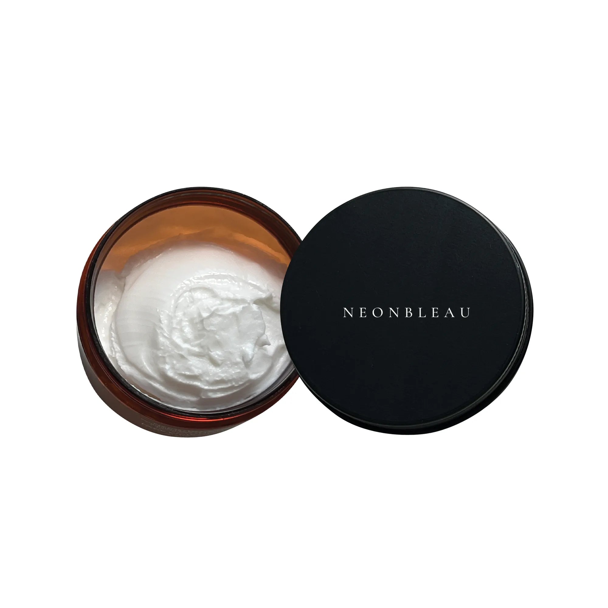 An open amber jar of white moisturizer next to its black lid with "NEONBLEAU" written on it.