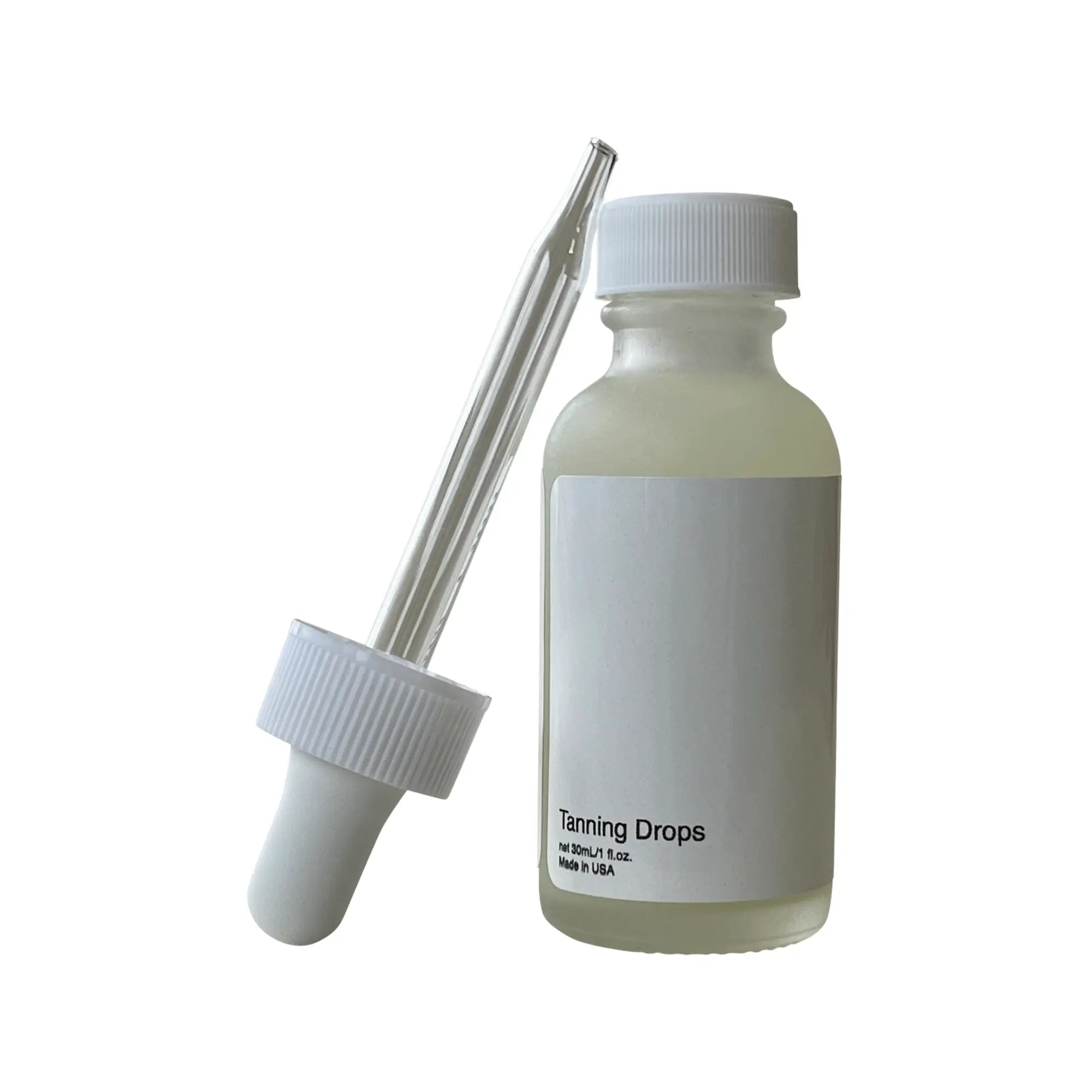 A white bottle of tanning drops with a dropper next to it.