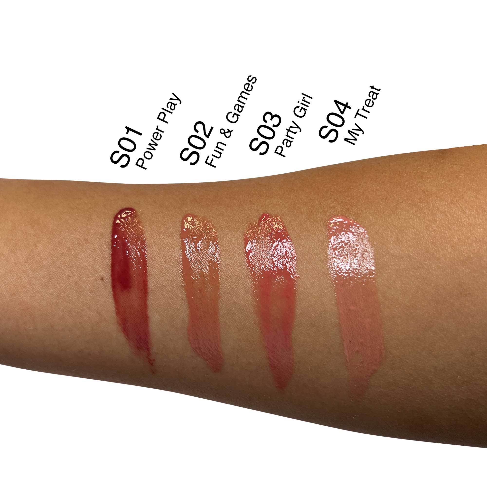 Four swatches of lip oil are shown on a person's arm.