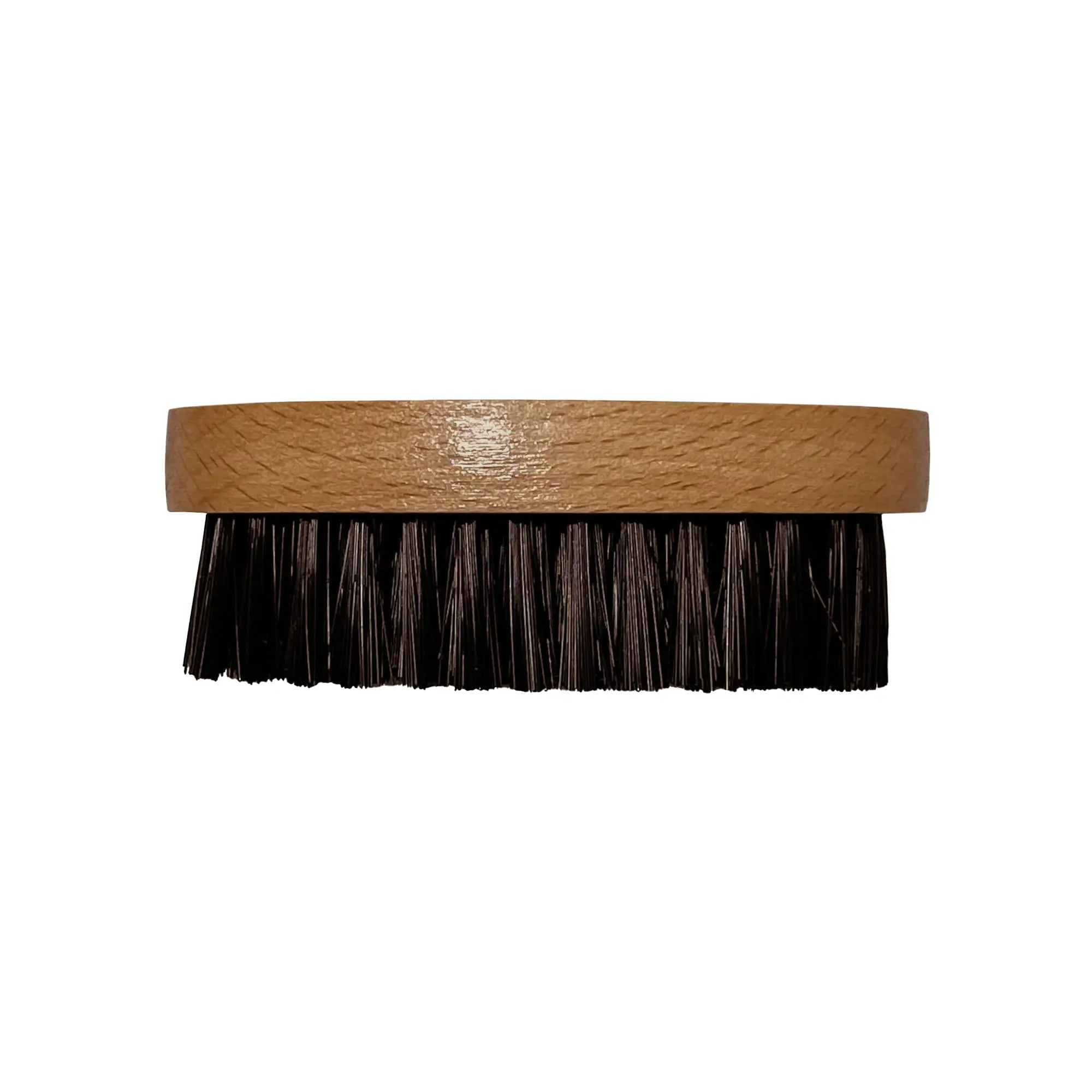 A round wooden beard brush with black bristles.
