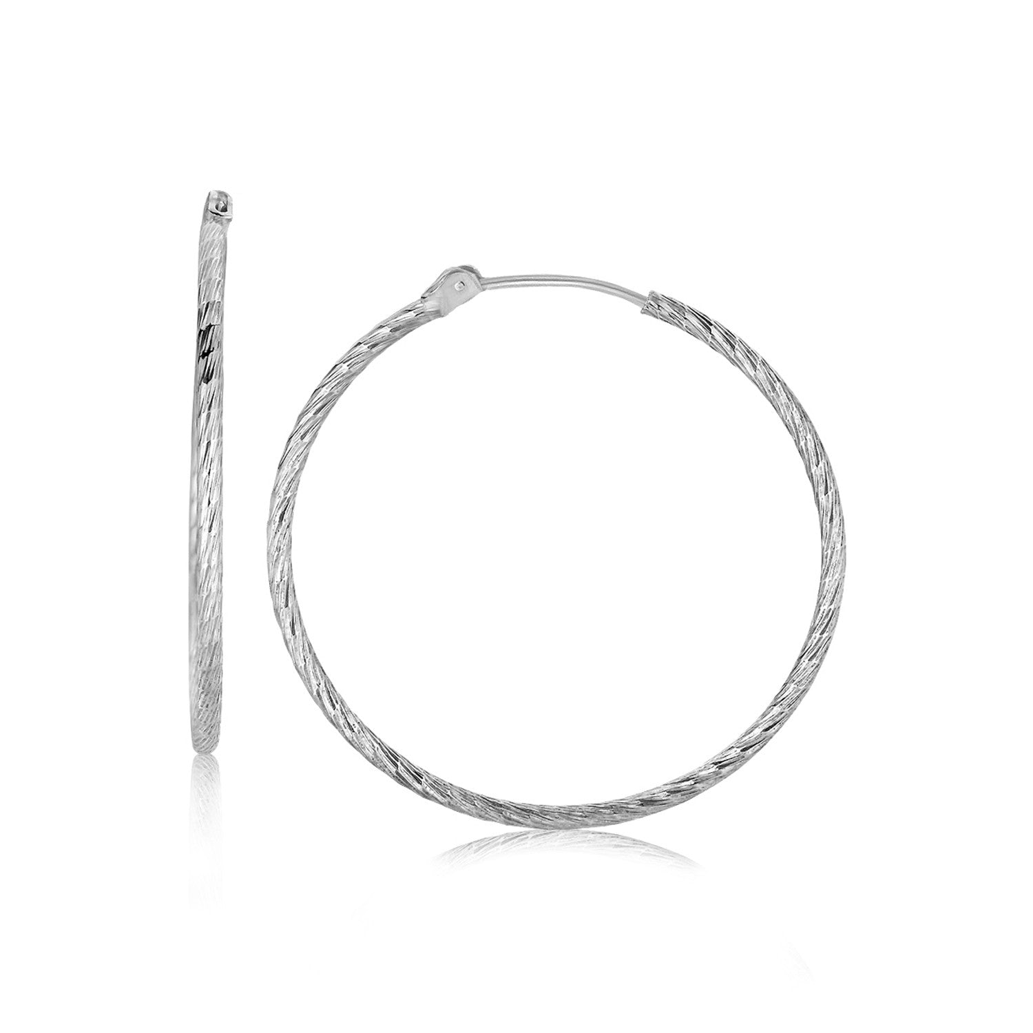 Sterling silver rhodium plated thin hoop diamond cut earrings with a reflective surface.
