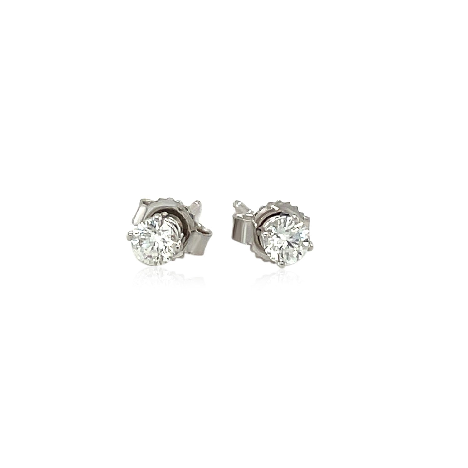 Two 14k white gold diamond four-prong stud earrings with push backs.