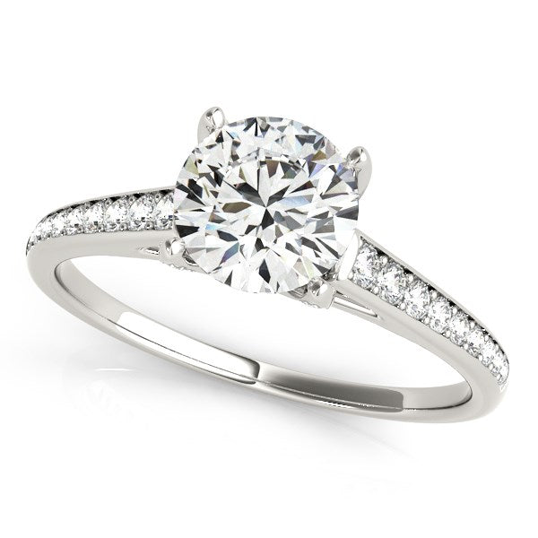 14k white gold diamond engagement ring with a round center stone and pavé band.