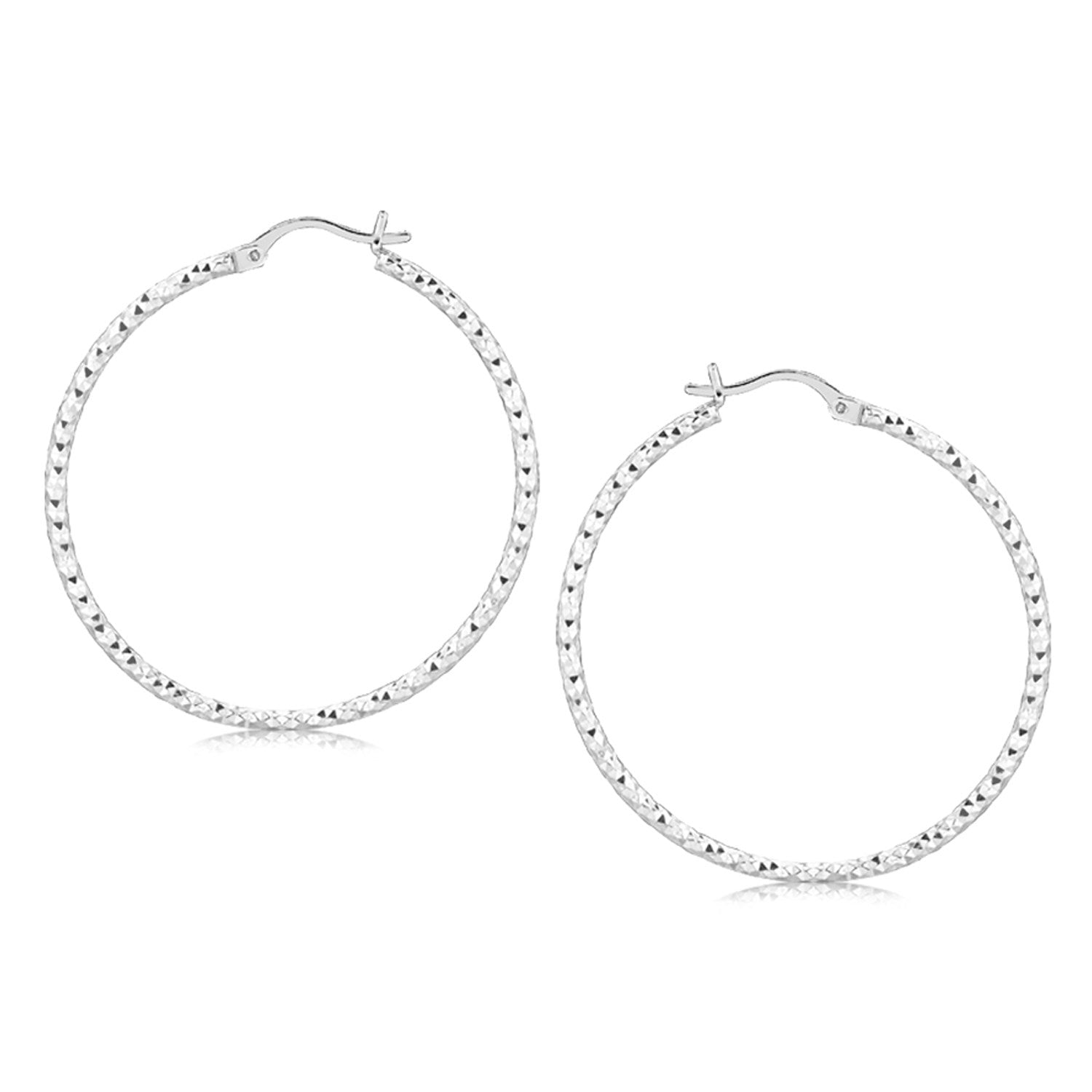 A pair of sterling silver rhodium plated large faceted hoop earrings.