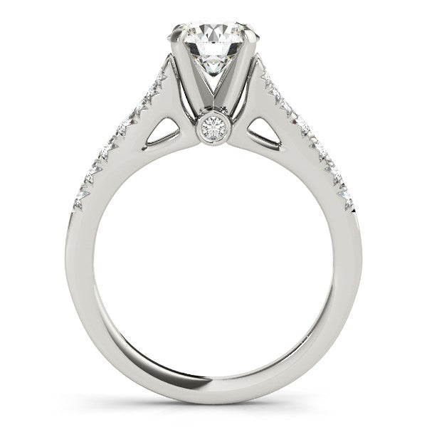 A 14k white gold split shank engagement ring with a round diamond and side stones.