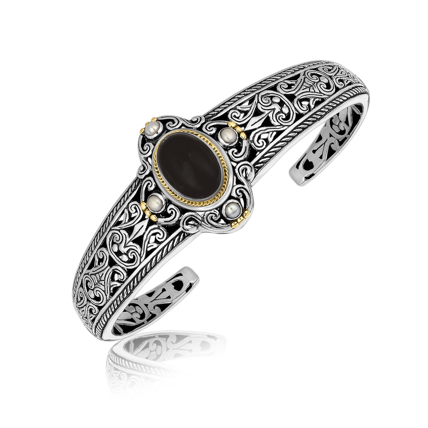 Sterling silver and 18K yellow gold bangle with an oval black onyx and pearls.
