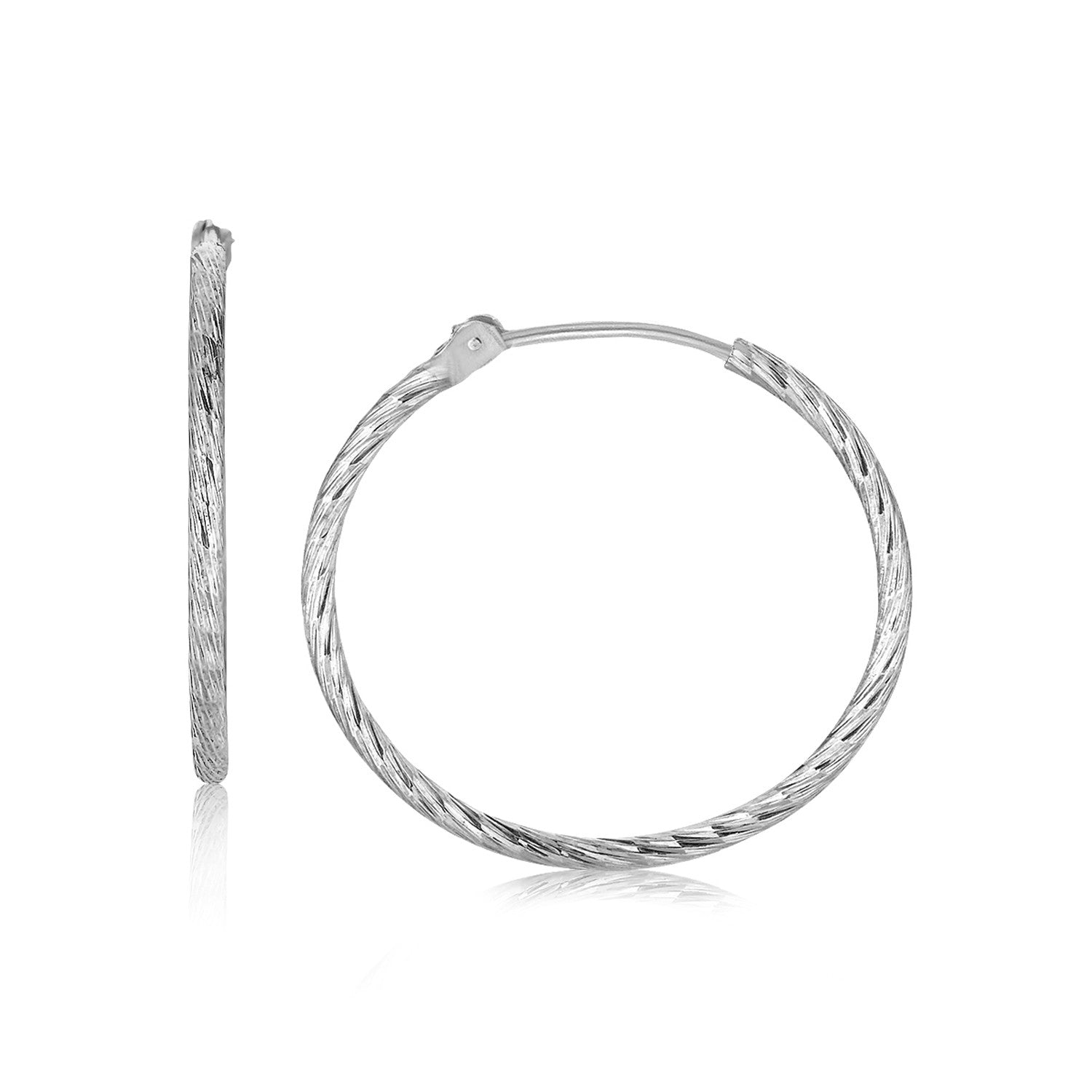 Sterling silver slim rhodium-plated hoop earrings with a diamond-cut texture.