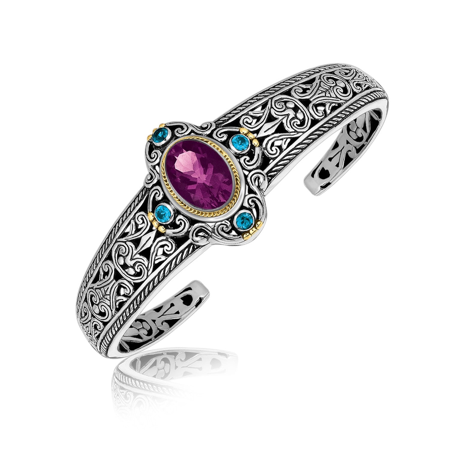 Sterling silver bangle with an oval amethyst, blue topaz, and gold accents.