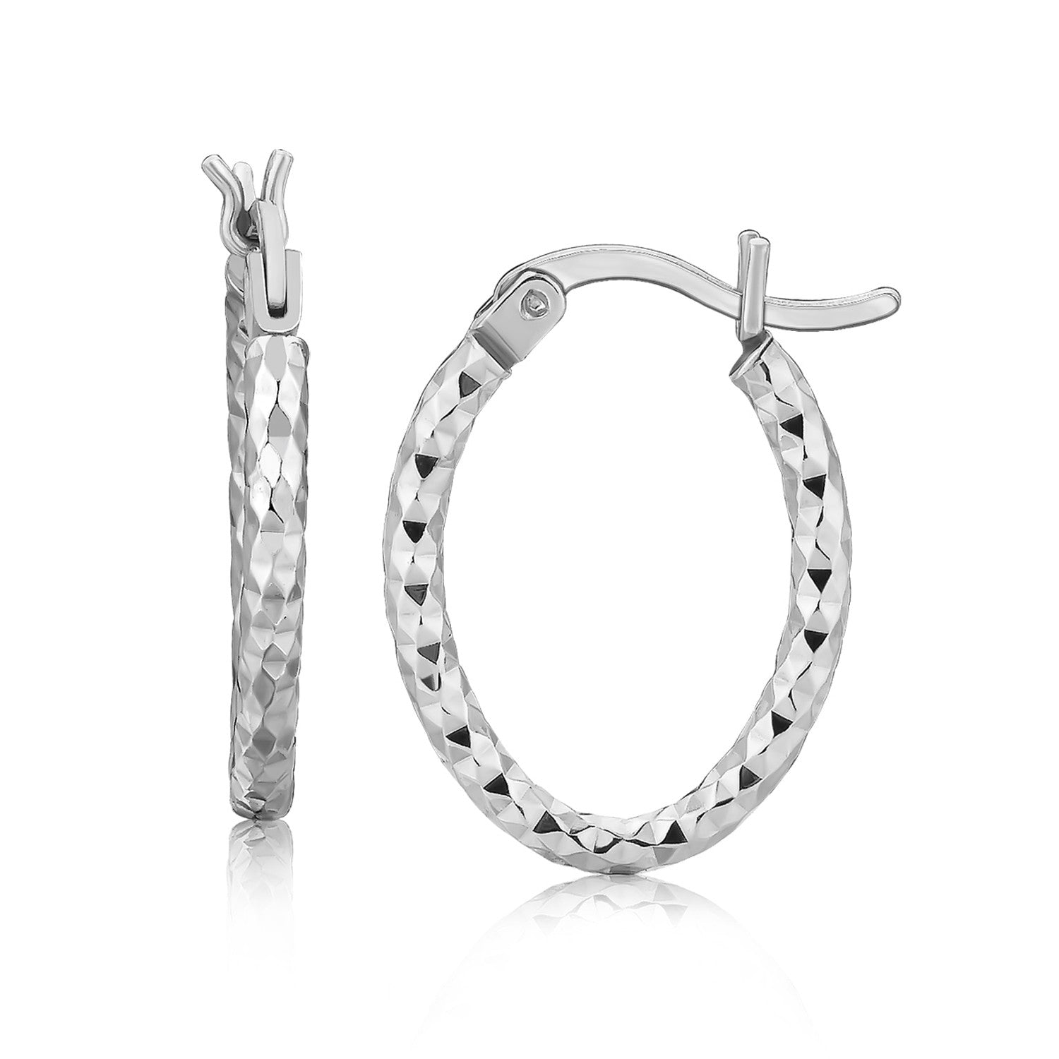 Sterling silver rhodium-plated oval hoop earrings with a diamond-cut textured finish.
