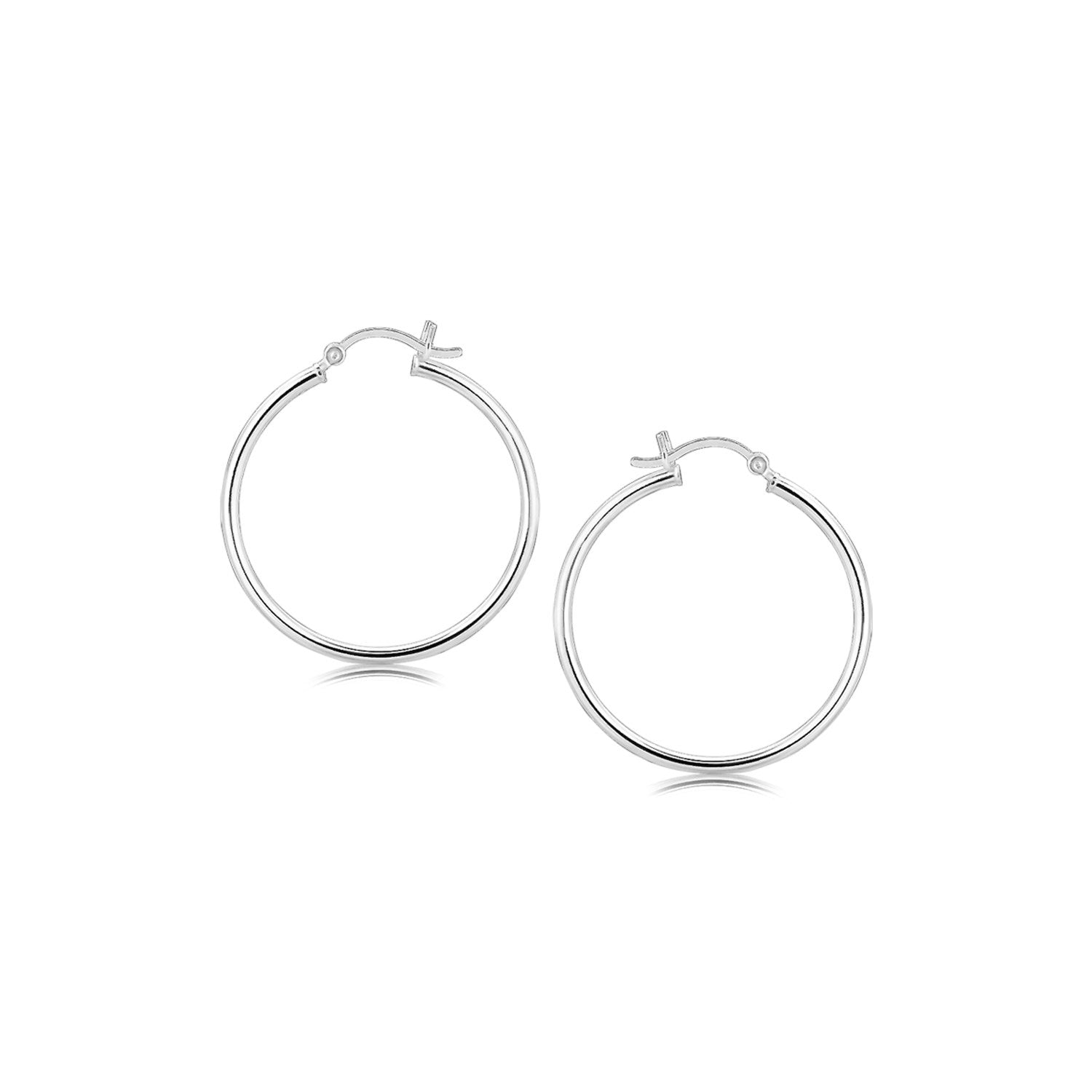 A pair of thin, polished sterling silver hoop earrings with rhodium plating.