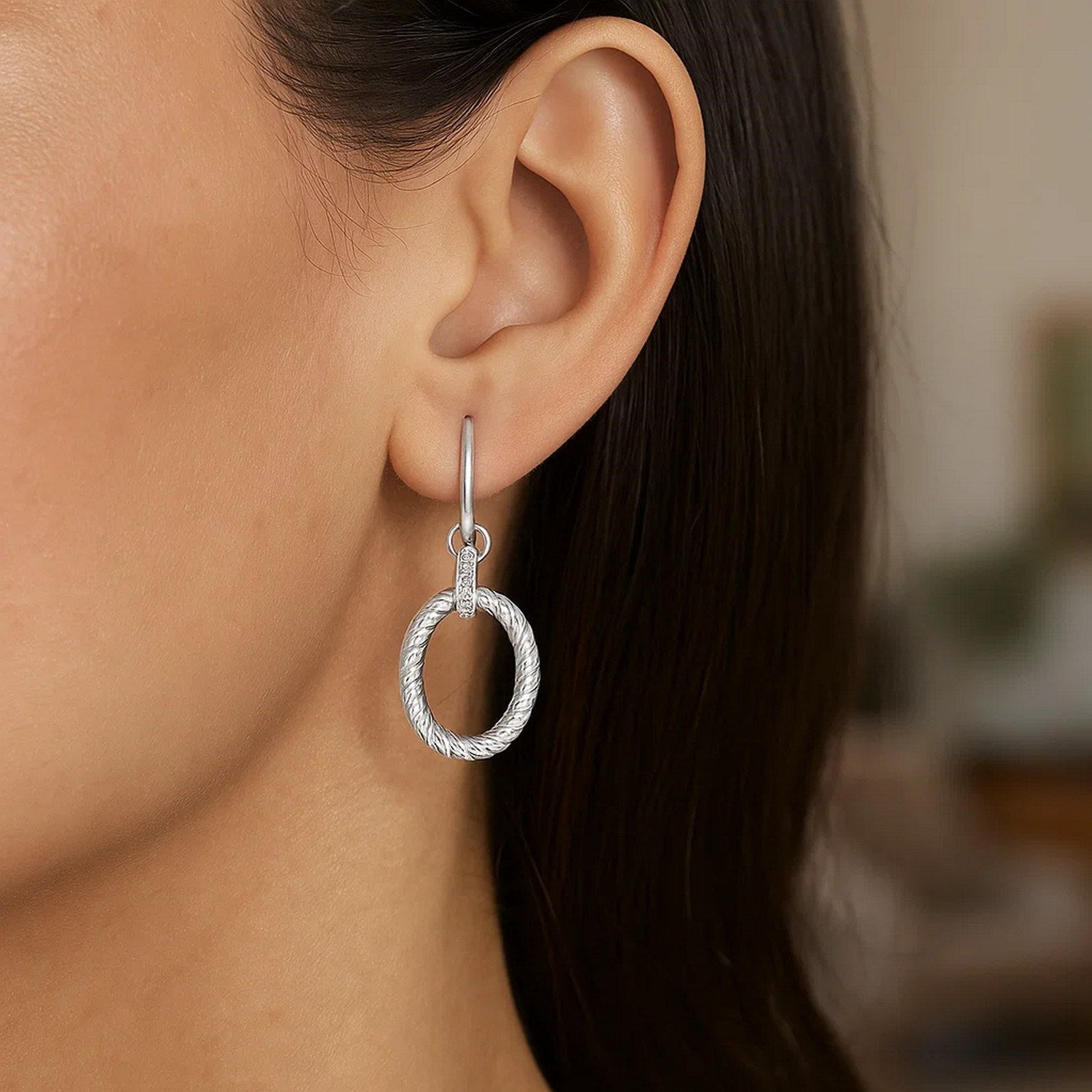 Sterling silver rhodium finished oval rope drop earrings with diamond embellishments.