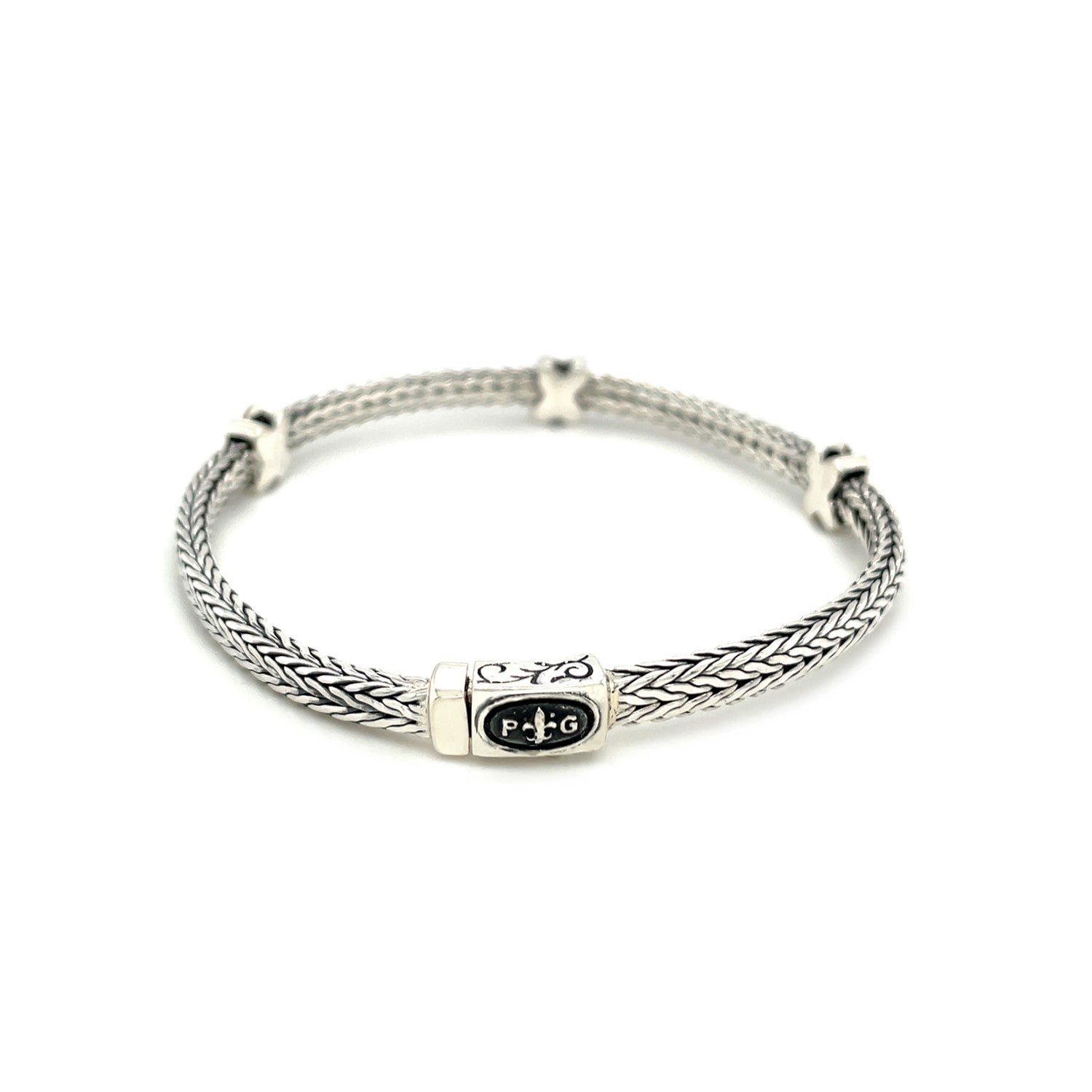 Woven rope sterling silver bracelet with black sapphire X accents and a box clasp.