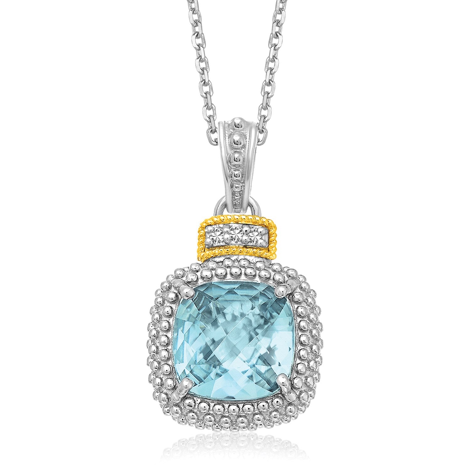 Sterling silver and 18k yellow gold pendant with a cushion-cut blue topaz and diamonds.