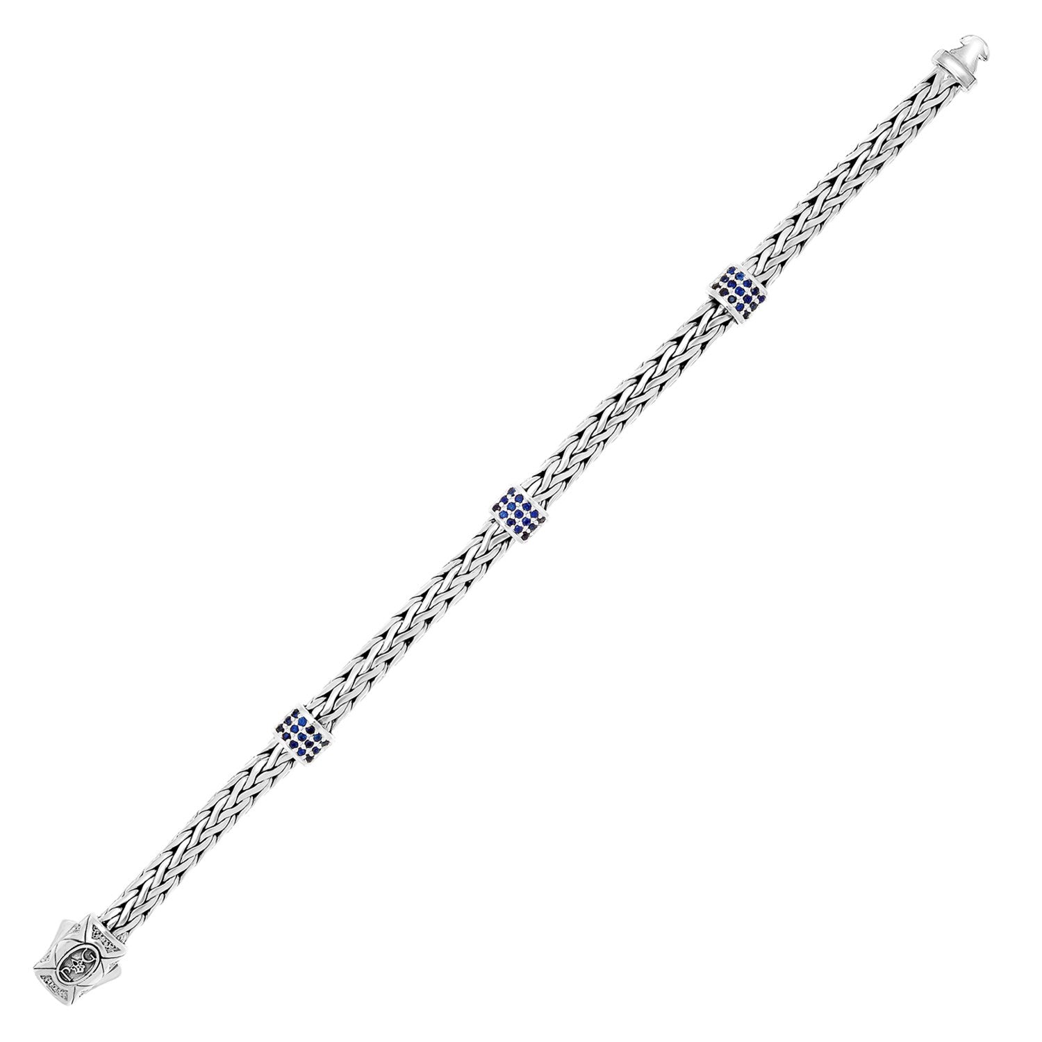 Sterling silver woven bracelet with three blue sapphire stations and a button safety lock.
