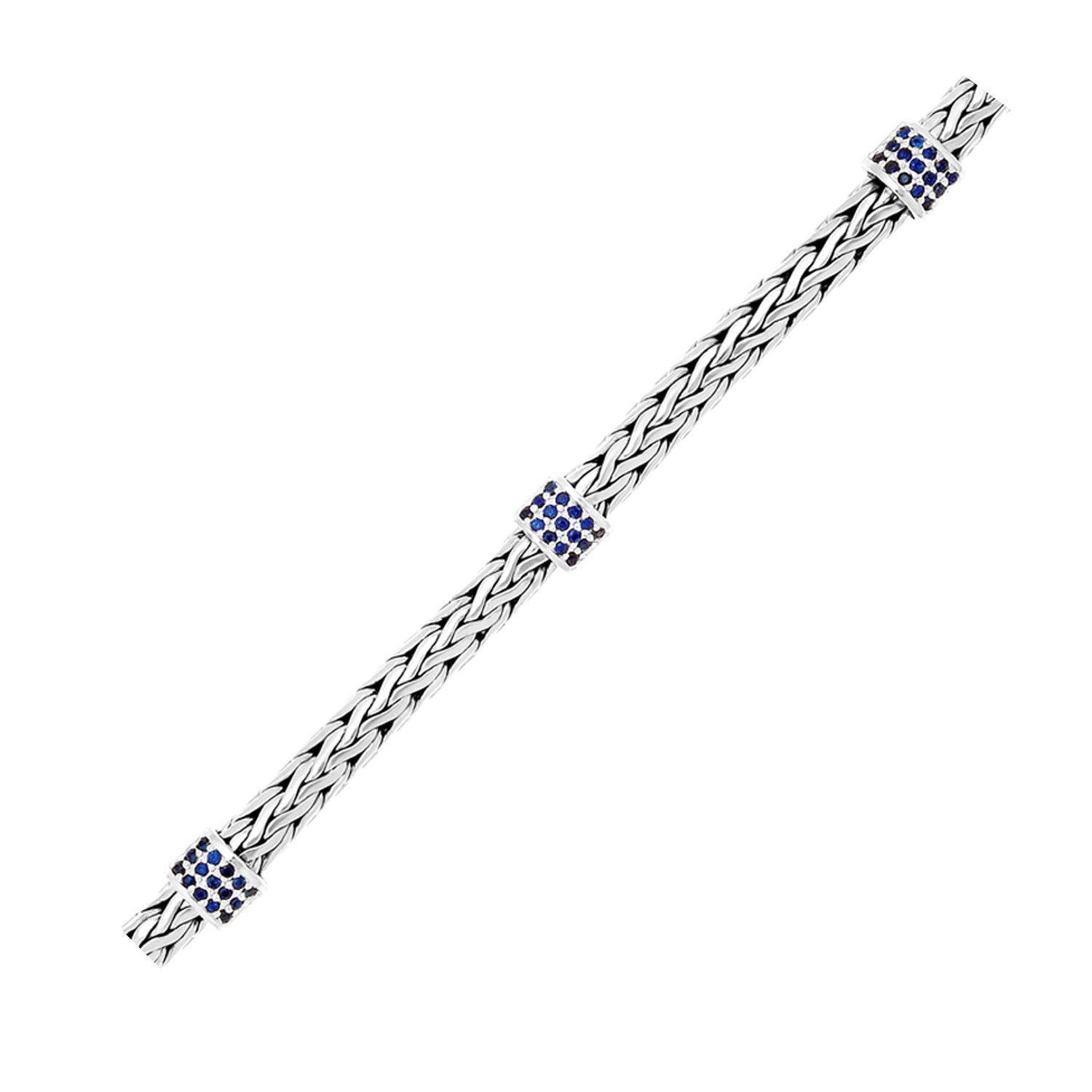 Sterling silver woven bracelet with three blue sapphire stations.