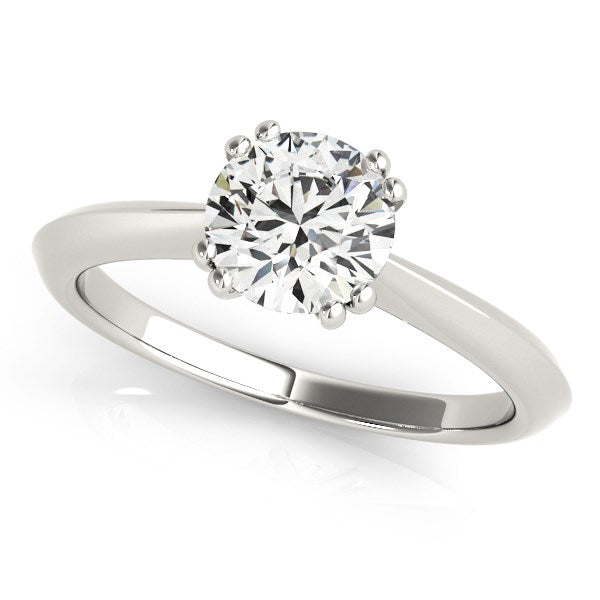 14k white gold solitaire engagement ring with a round diamond in a double prong setting.