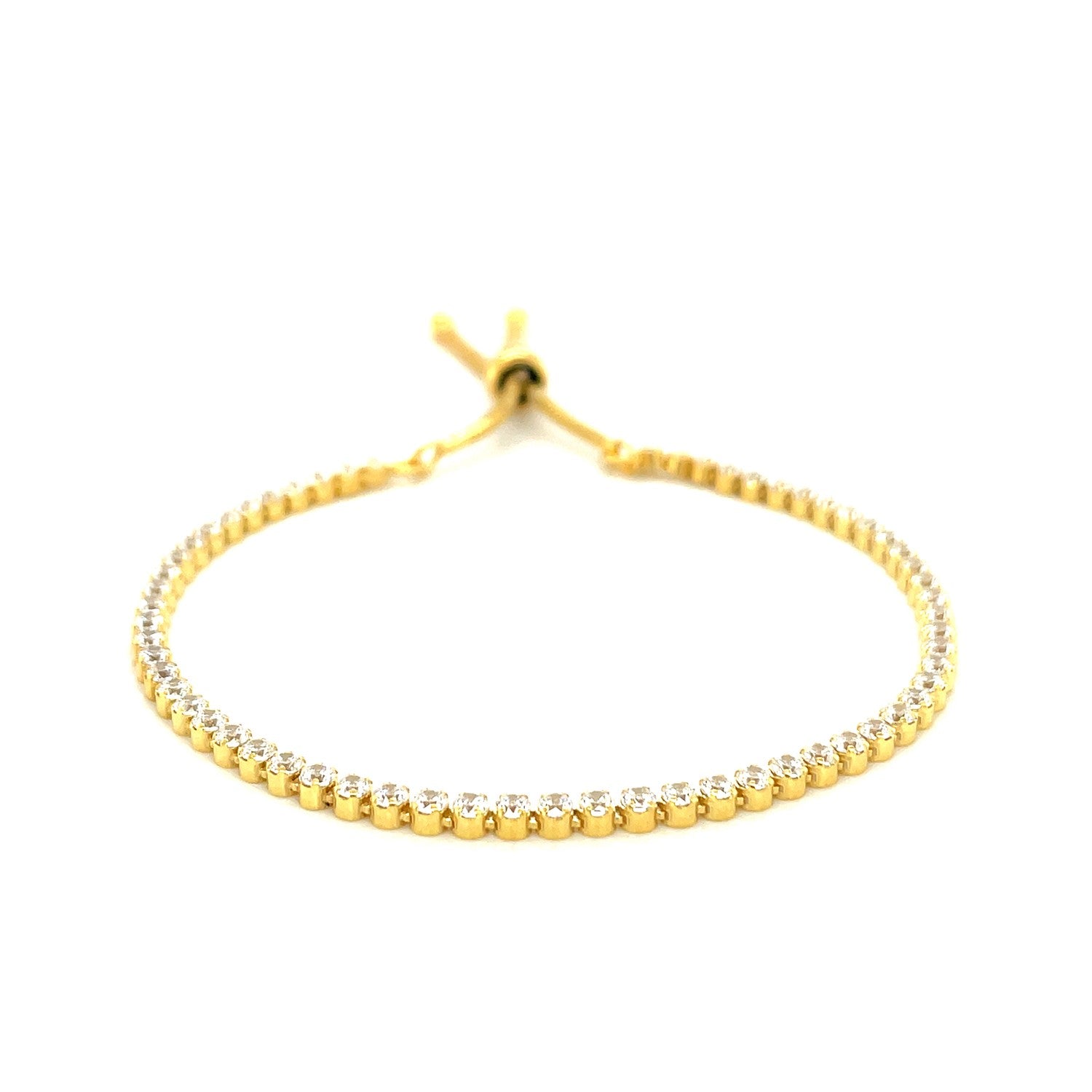 Adjustable tennis style bracelet with round cubic zirconia in yellow-toned sterling silver.