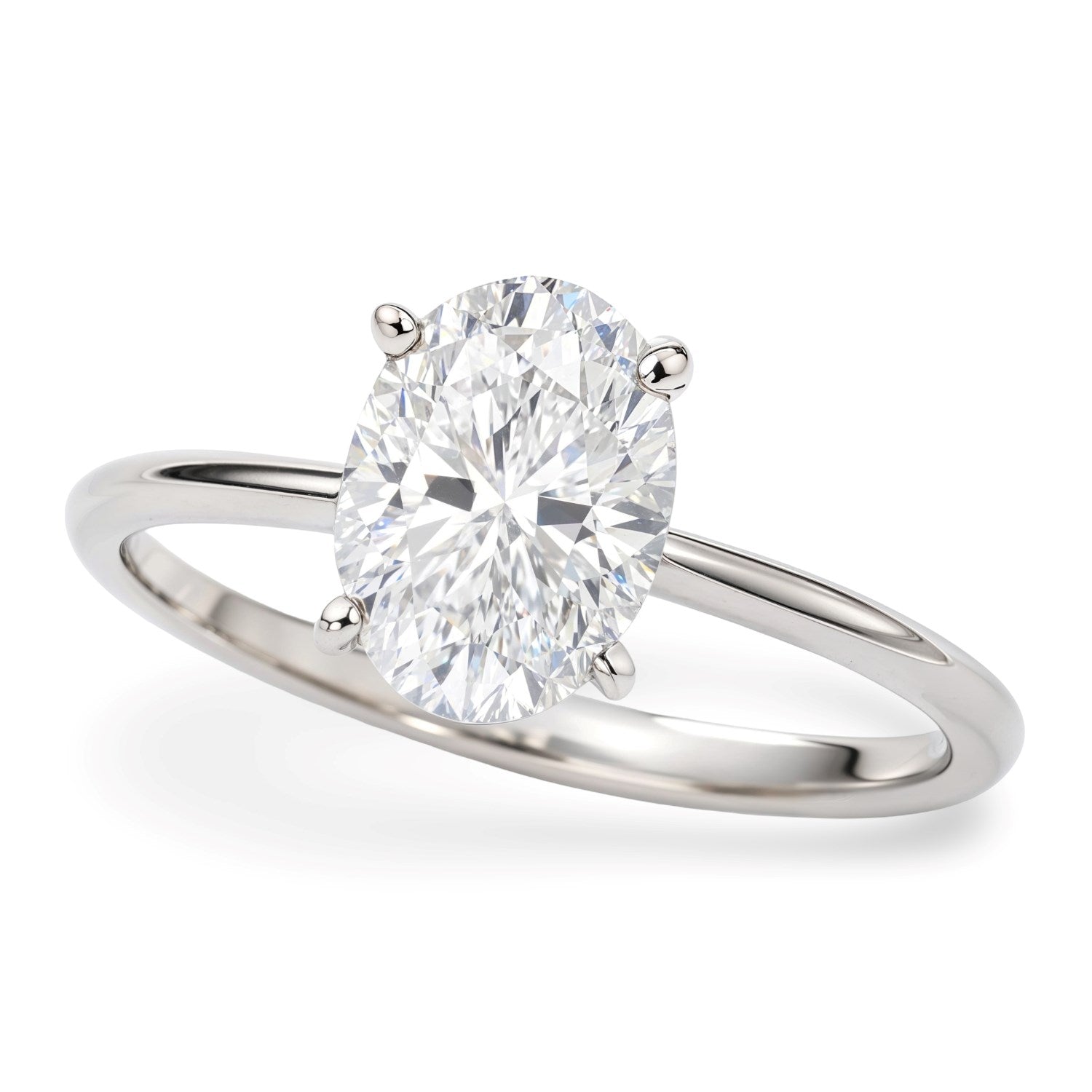 A 14K white gold solitaire ring with an oval lab-grown diamond in a four-prong setting.