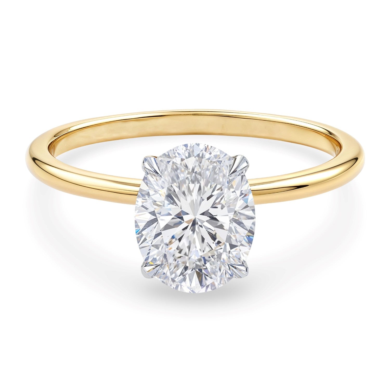 Oval lab grown diamond solitaire ring with a yellow gold band.