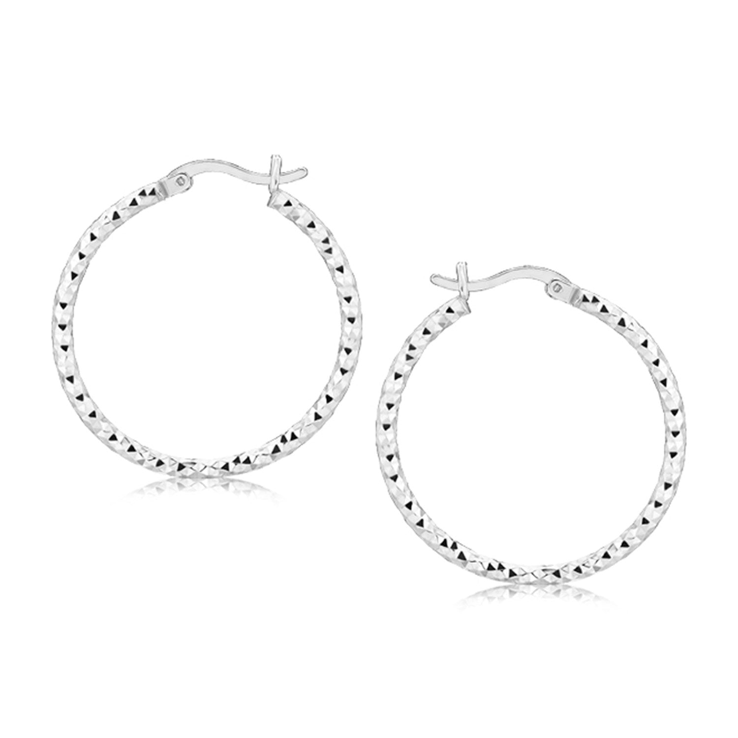 Sterling silver faceted hoop earrings with rhodium plating and snap locks.
