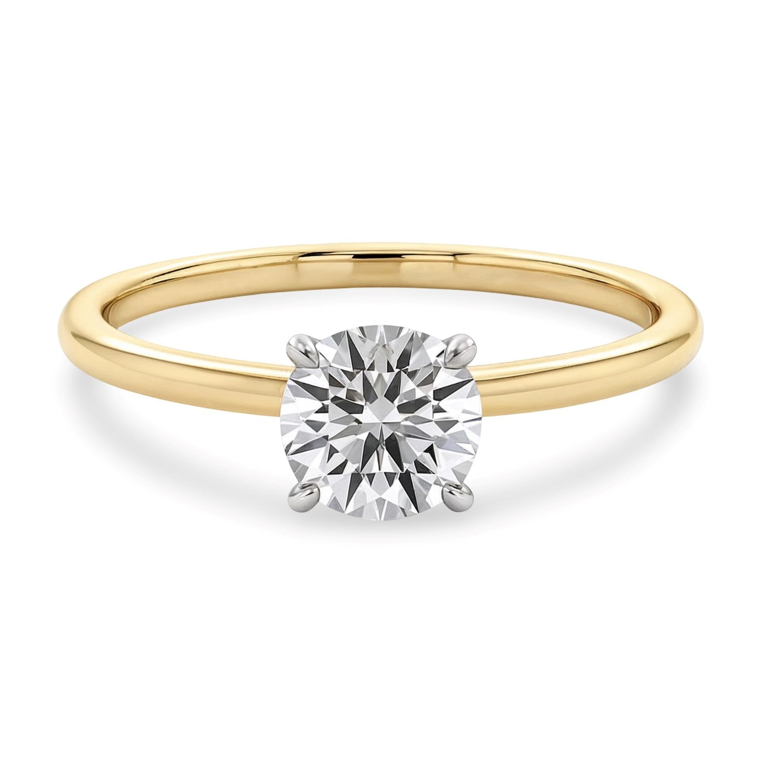 A round lab-grown diamond solitaire ring with a yellow gold band and white gold prongs.