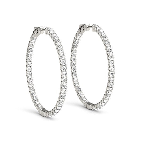 A pair of 14k white gold diamond hoop earrings with a shared prong setting.