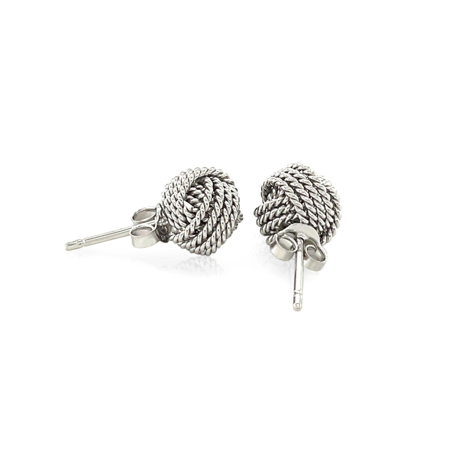 Sterling silver textured love knot stud earrings with a push-back closure.