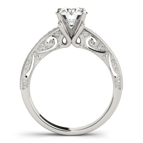 14k white gold antique engagement ring with a round diamond and pave-set side stones.