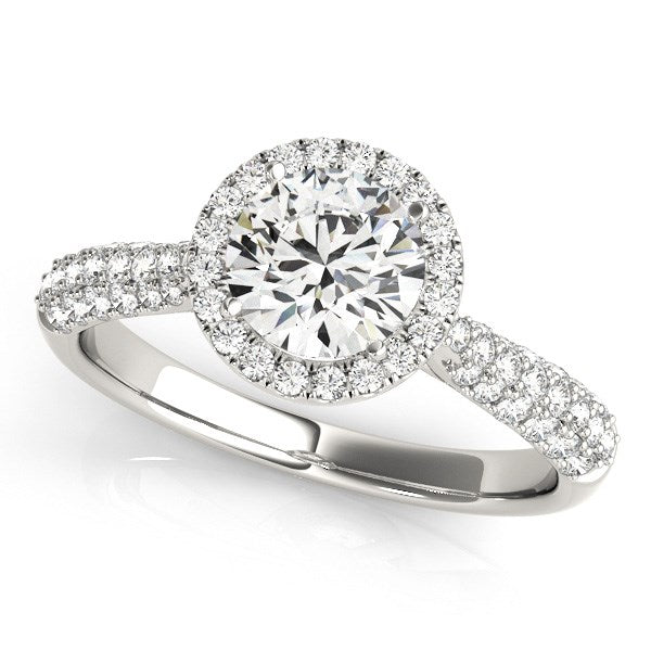 A 14k white gold halo diamond engagement ring with a pave band.