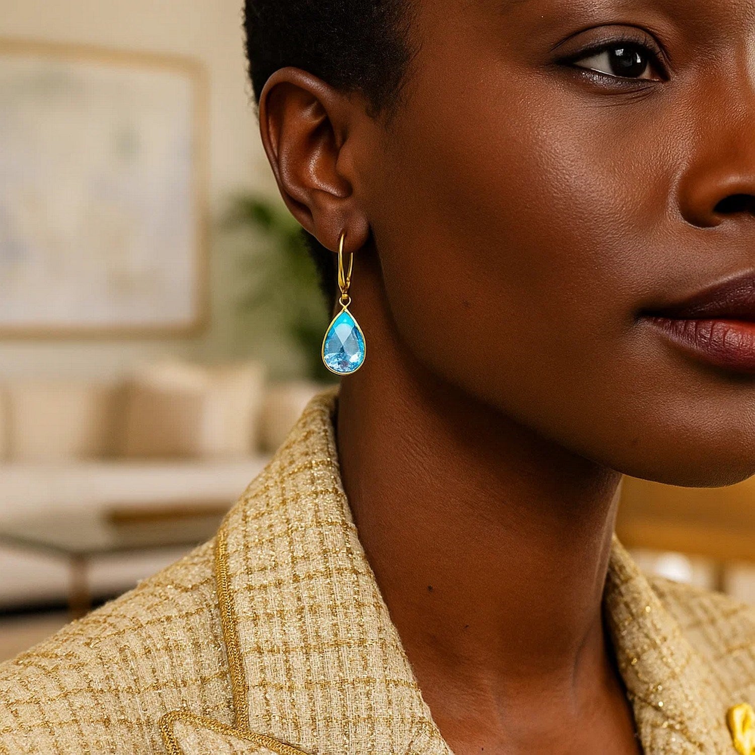 Drop earrings with pear-shaped blue topaz briolettes in 14k yellow gold.