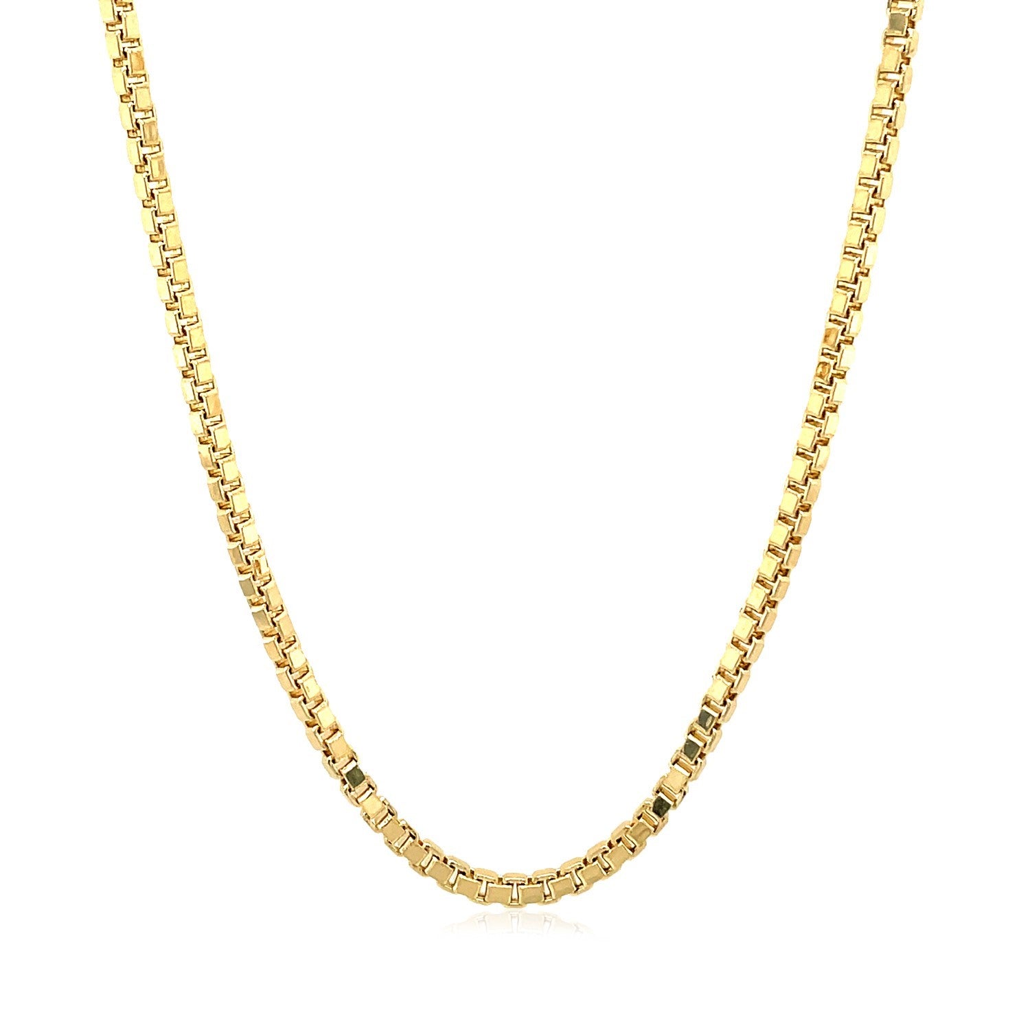 A 14k yellow gold semi-solid box chain is draped in a U-shape.