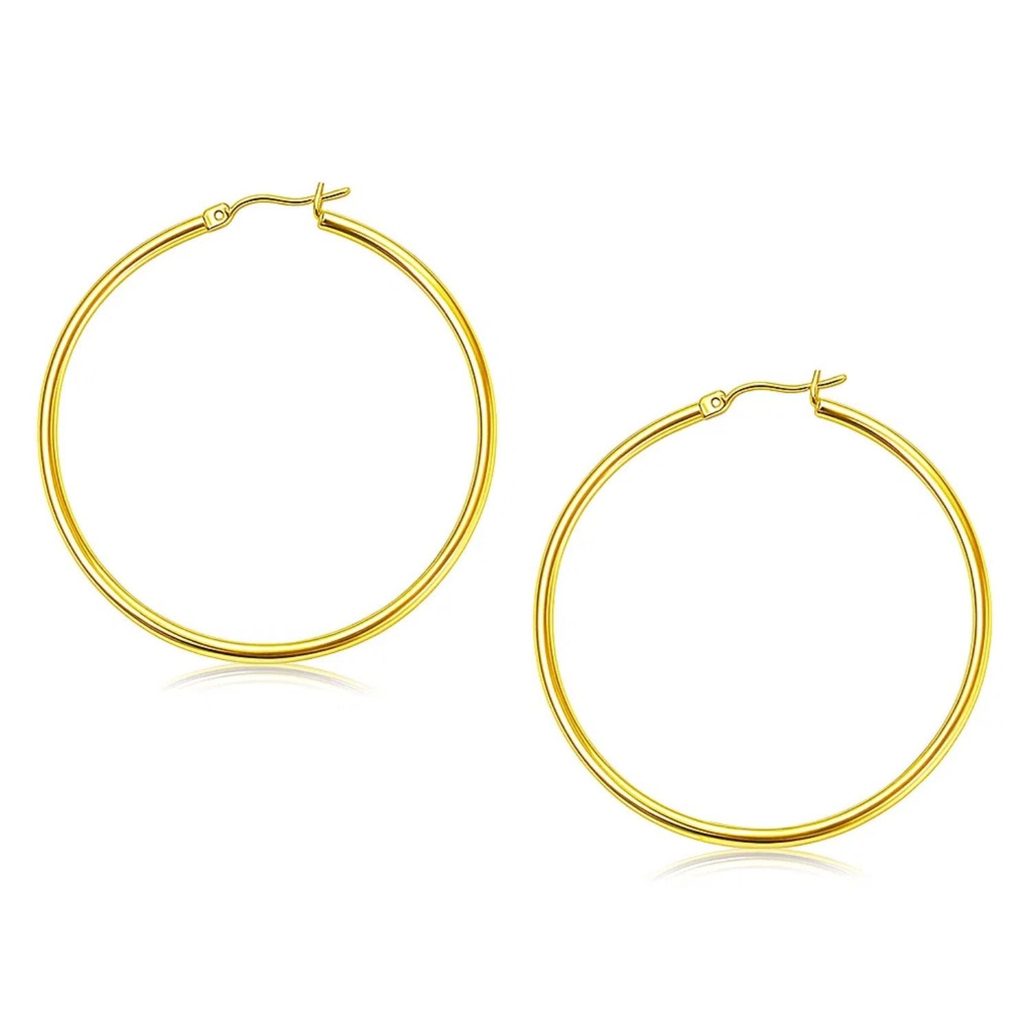 A pair of polished 10k yellow gold hoop earrings with snap lock backings.