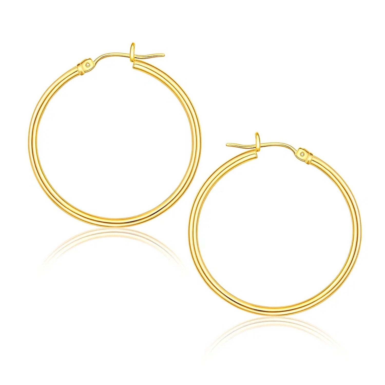 A pair of polished 10k yellow gold hoop earrings with snap lock backings.