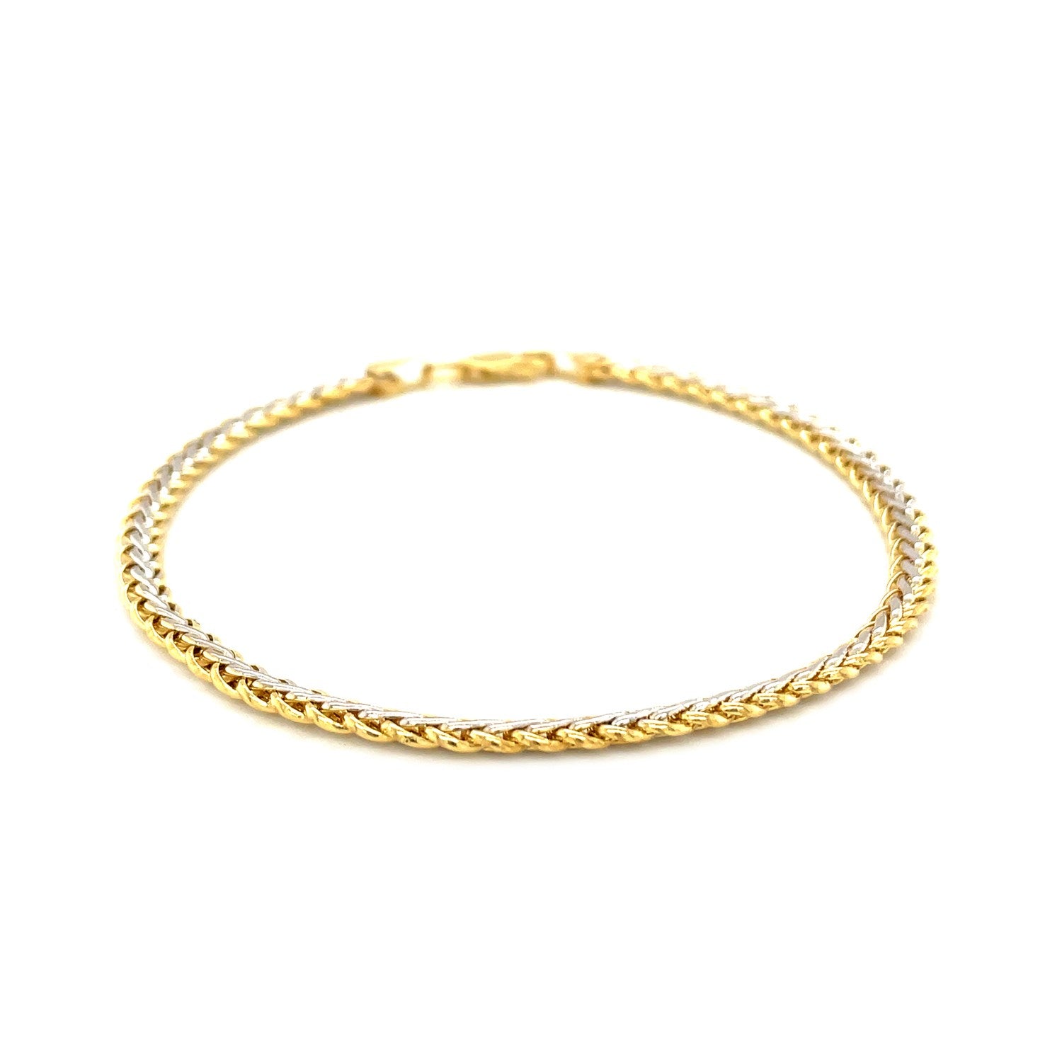 Two-toned 10k yellow and white gold wheat chain bracelet with a lobster clasp.