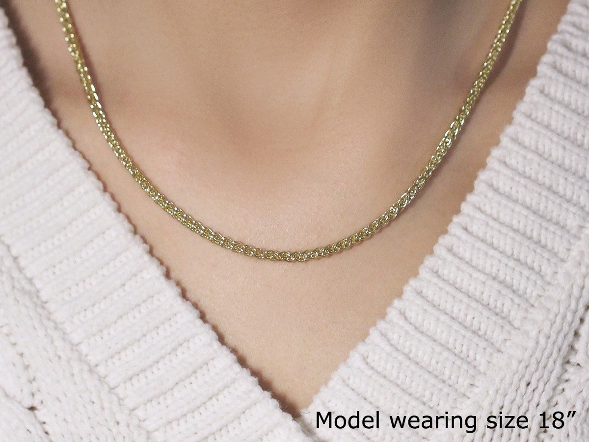 A model wears an 18-inch 14k yellow gold light weight wheat chain.