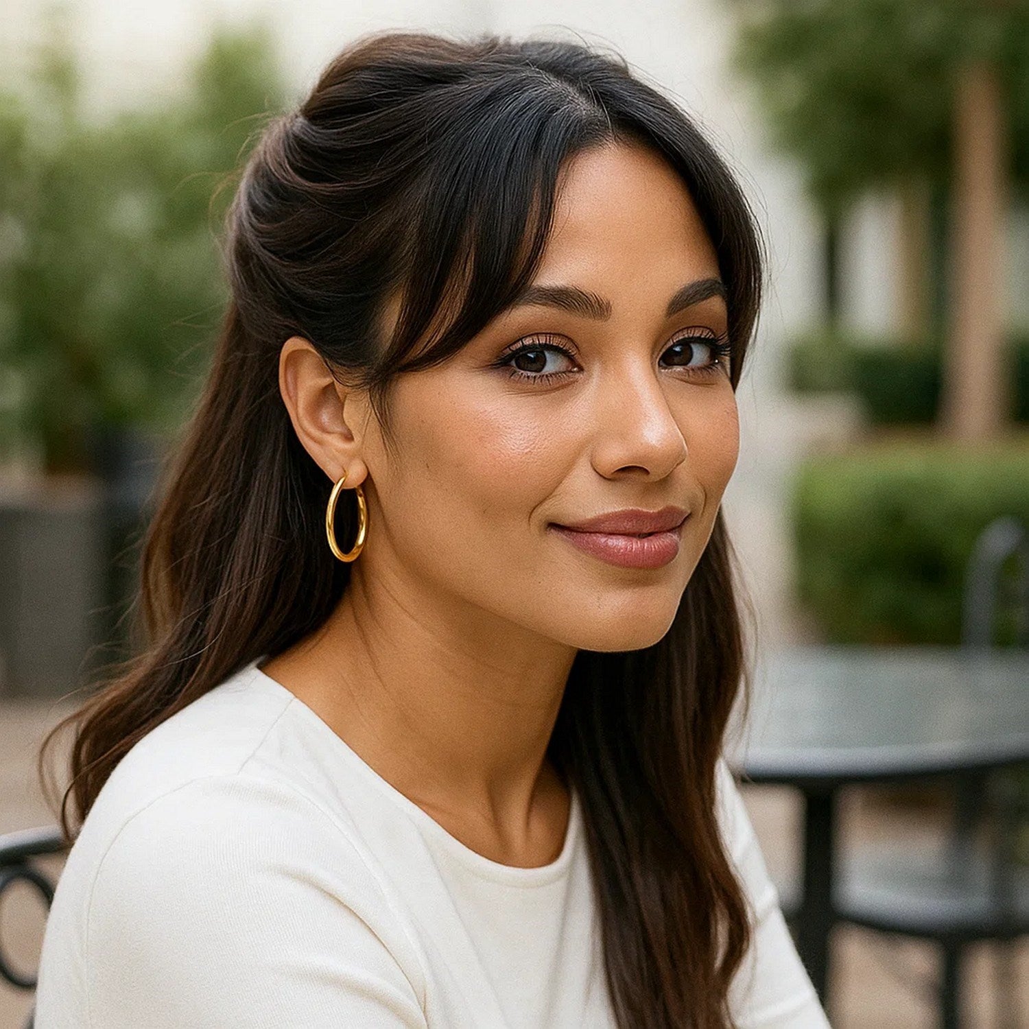 10k yellow gold polished hoop earrings on a woman with dark hair.