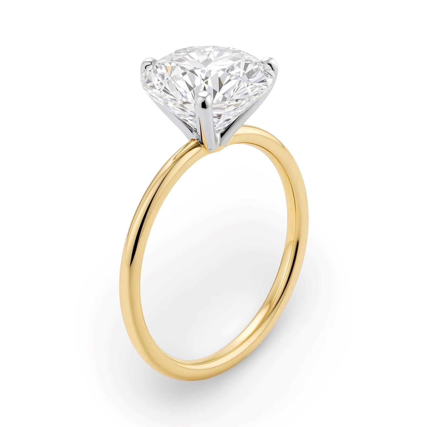 A round lab-grown diamond solitaire ring with a yellow gold band and white gold prongs.
