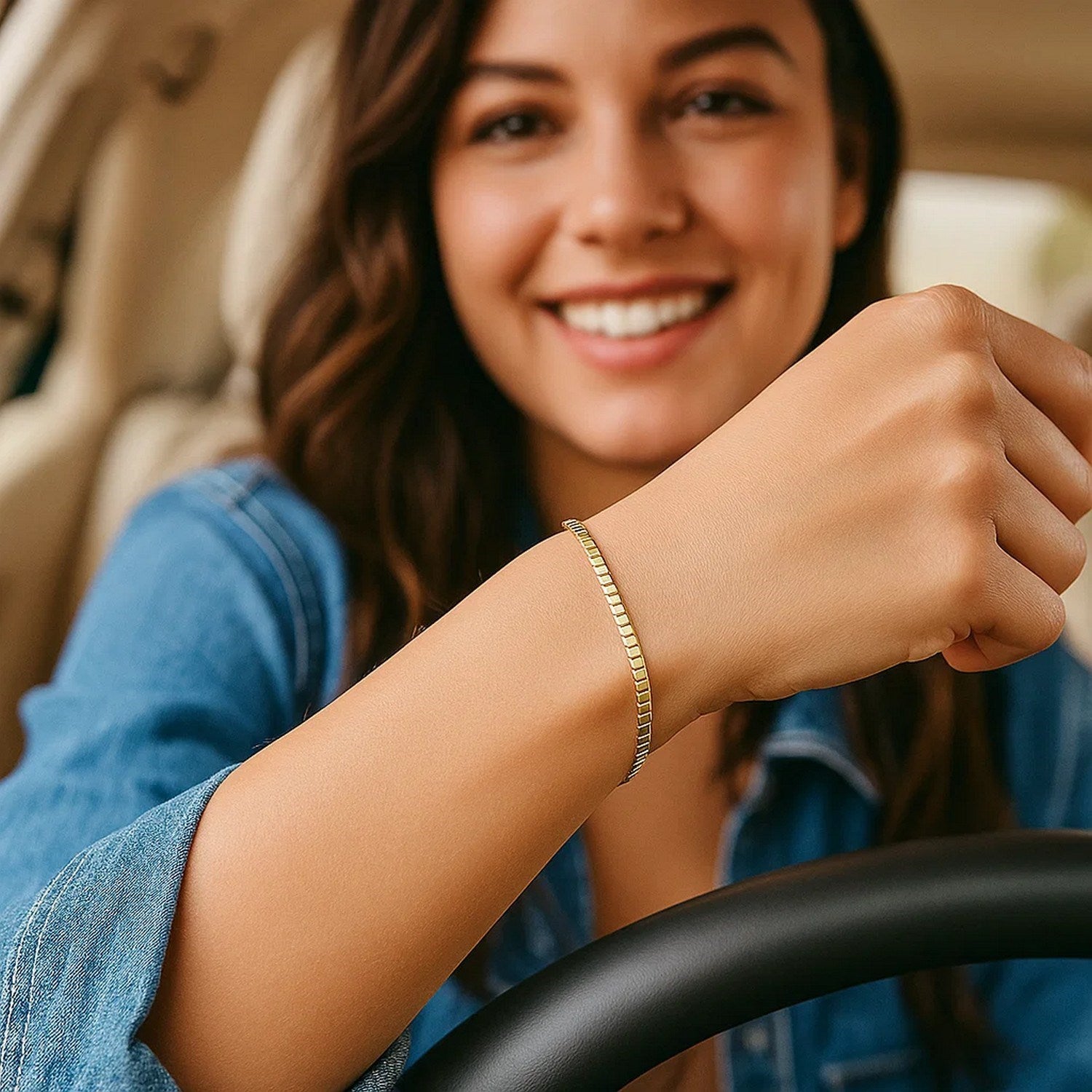 14k yellow gold brick omega bracelet on a woman's wrist while driving.