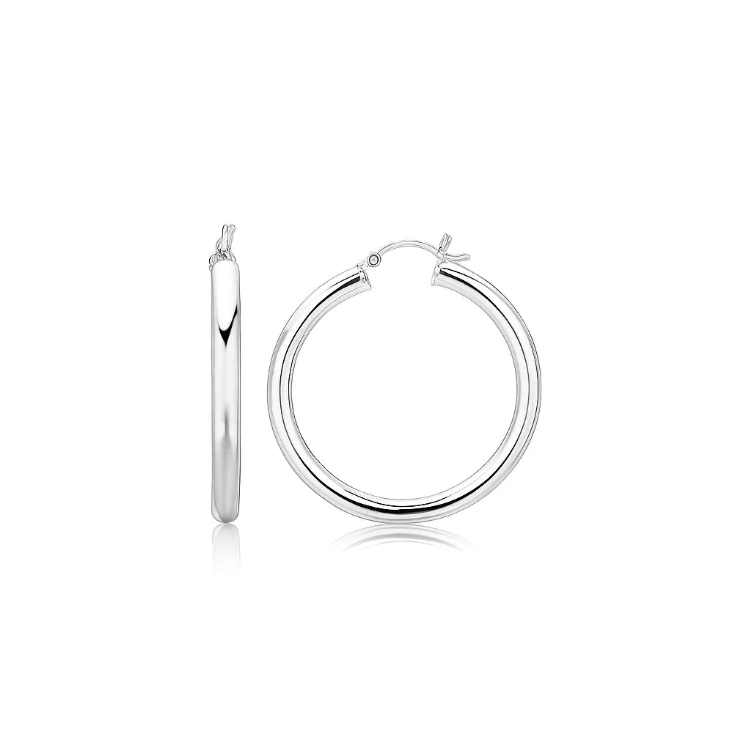 A pair of thick, polished, rhodium-plated sterling silver hoop earrings with snapbacks.