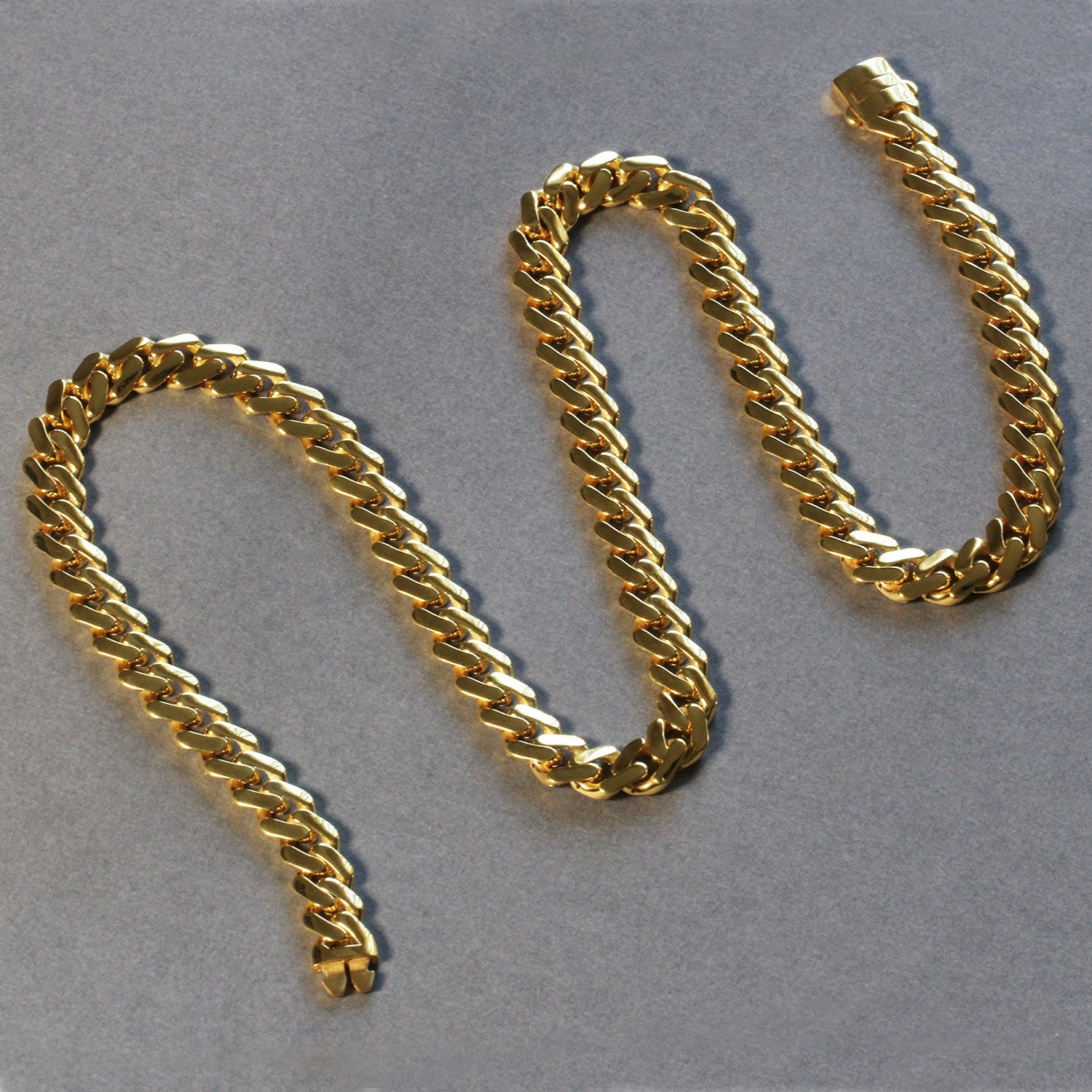 14k yellow gold 22-inch polished curb chain necklace with a box clasp.