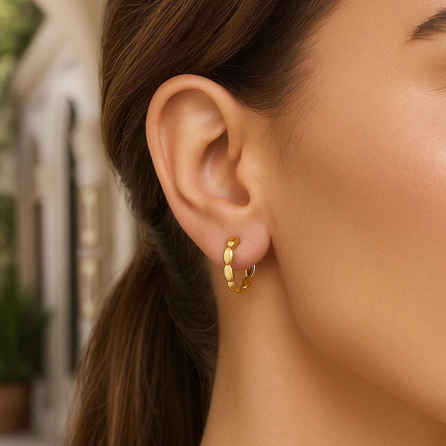 Medium rice hoop earrings in 14K yellow gold with a snap clasp.