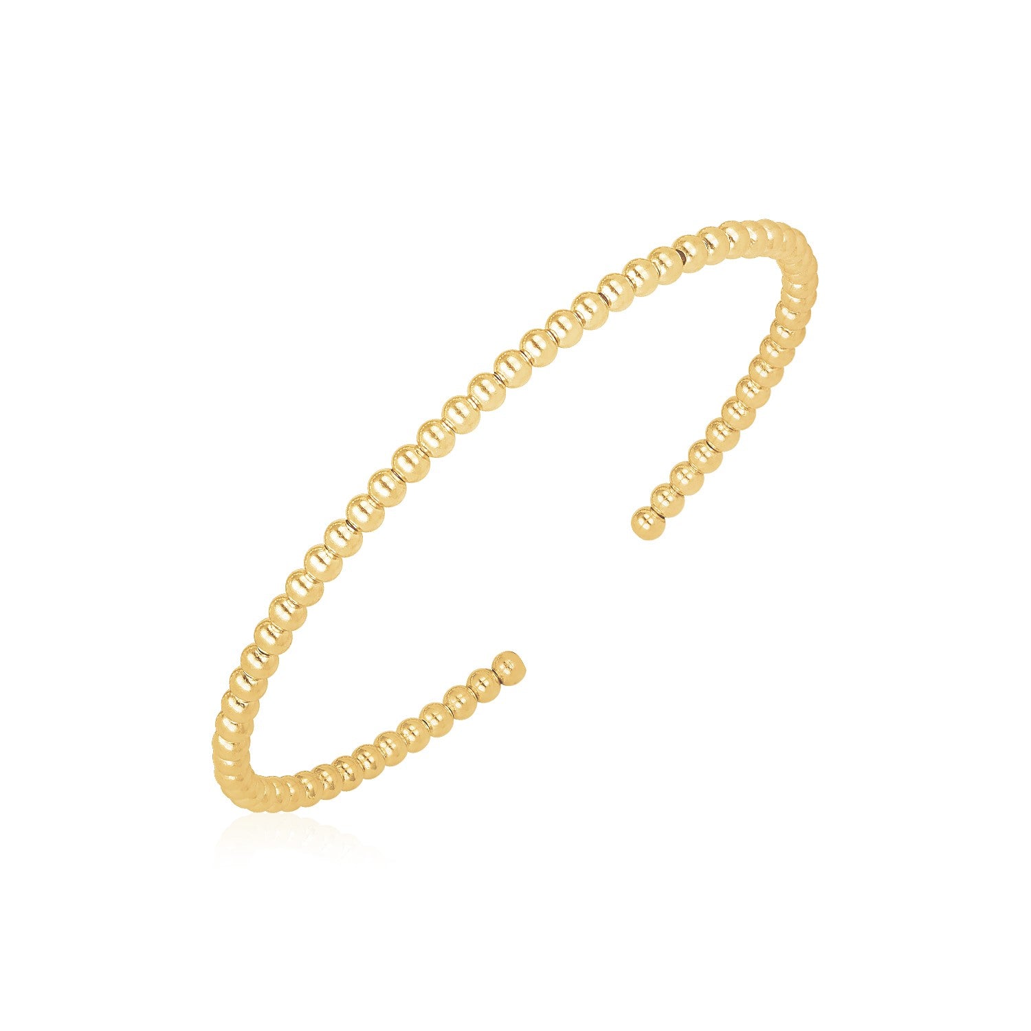 A shiny 14k yellow gold cuff bangle made of small, polished beads.